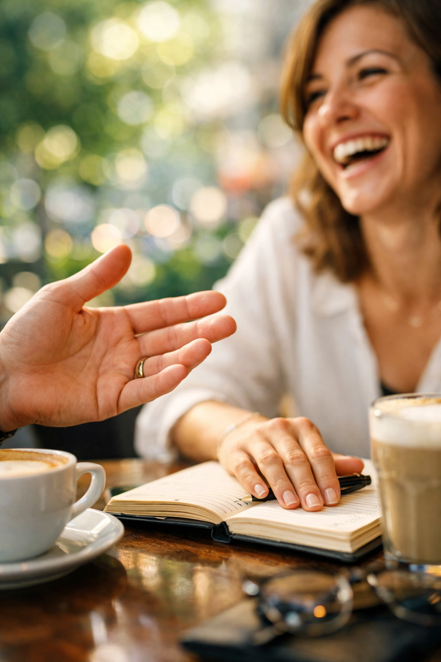A genuine human connection showing trust and rapport during a business conversation in a cafe.