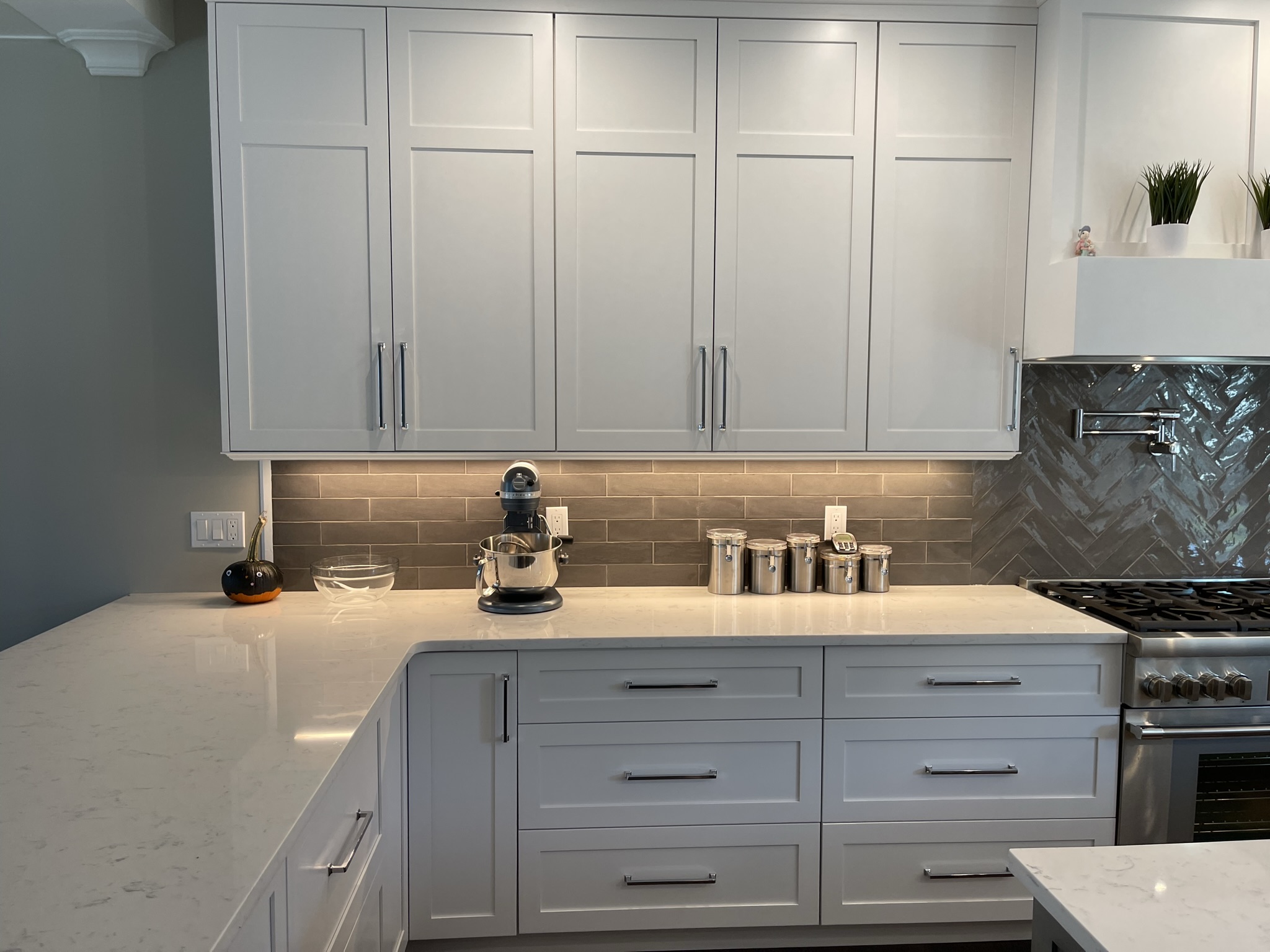 Custom-designed kitchen featuring white shaker-style cabinetry