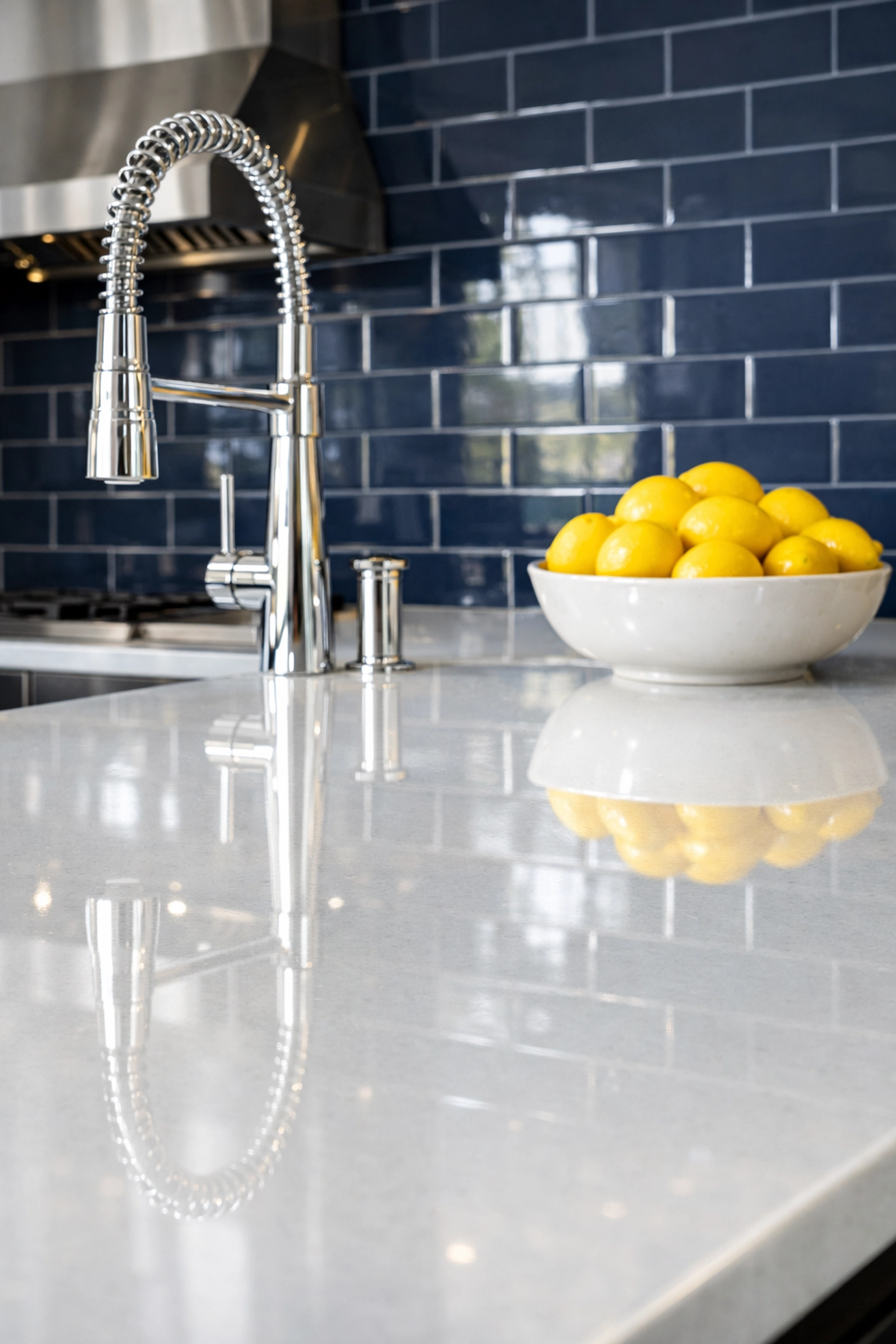 Spotless white quartz kitchen island and polished faucet representing expert house cleaning in Shrewsbury.