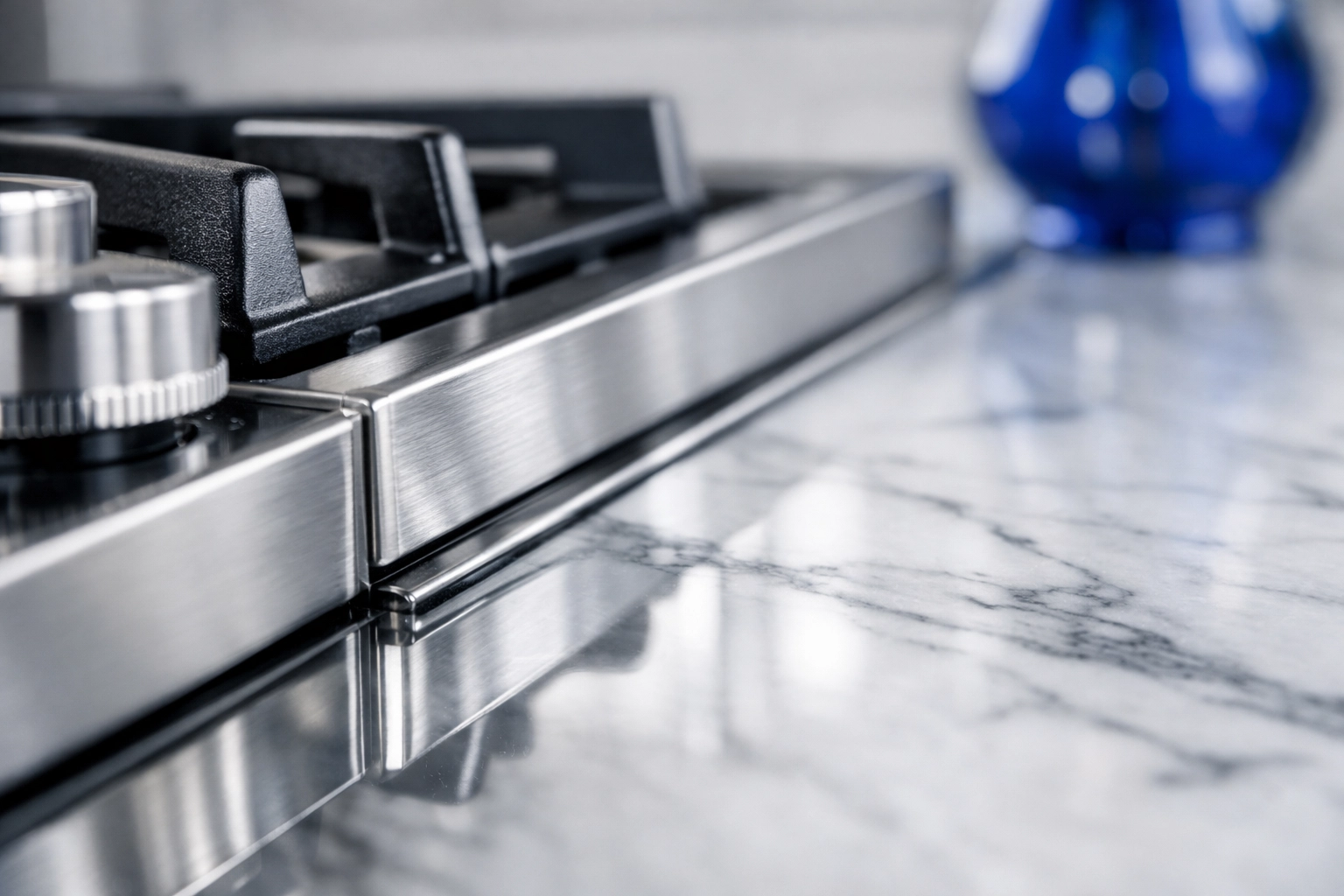 Spotless modern kitchen in a Massachusetts apartment with a polished marble countertop and deep cleaned stovetop.