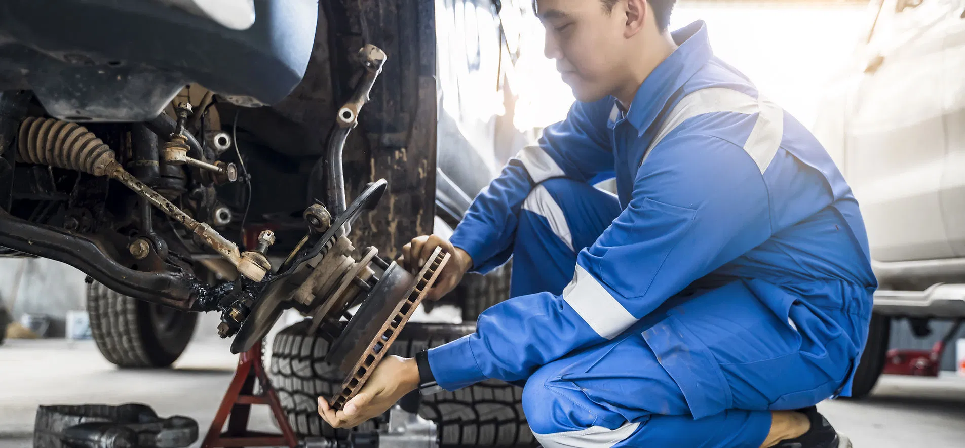 Technician working on brake rotor at Gibson's Auto Care