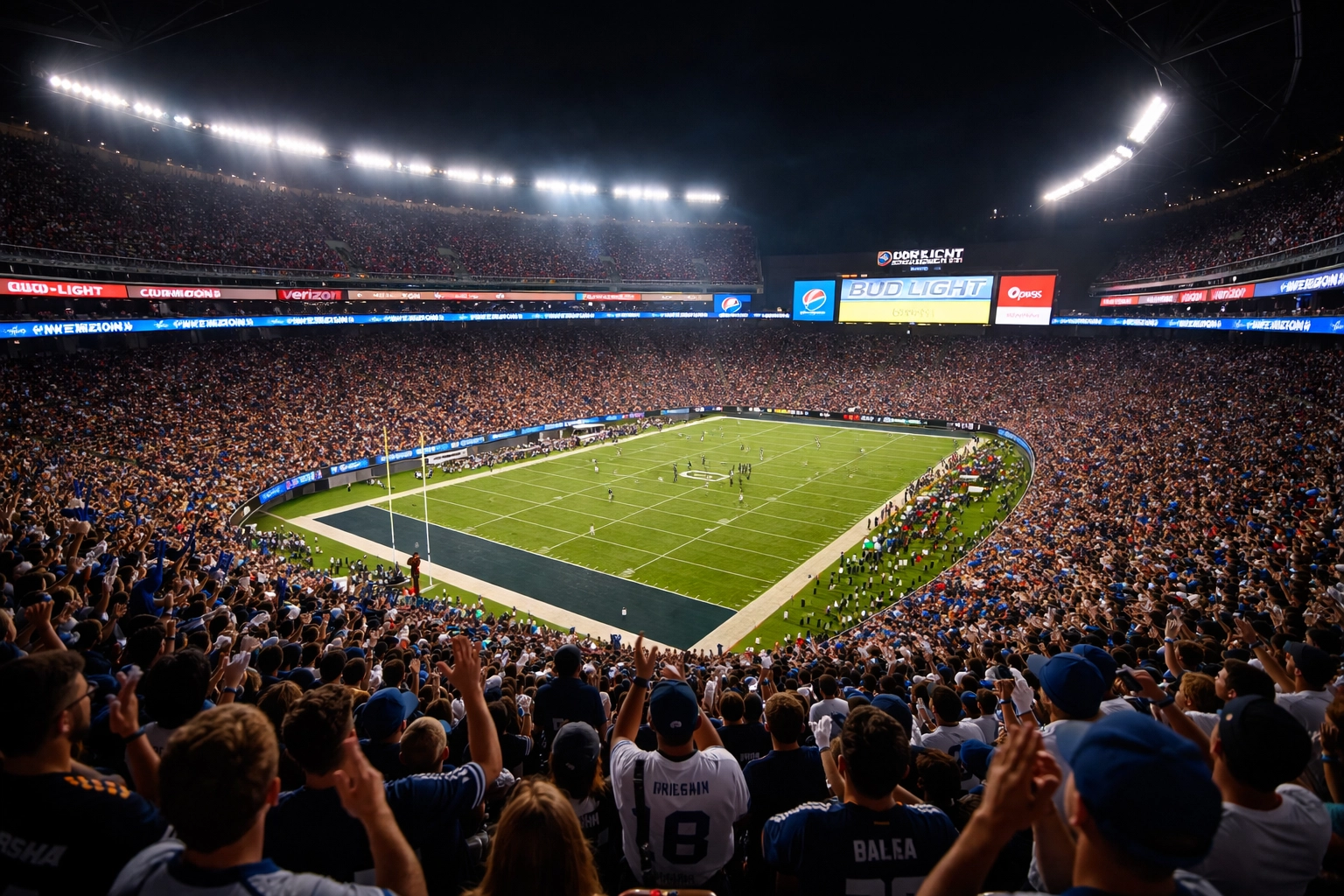 Full sports stadium at night with vibrant sponsor digital signage, illustrating high-impact venue marketing and advertising integration