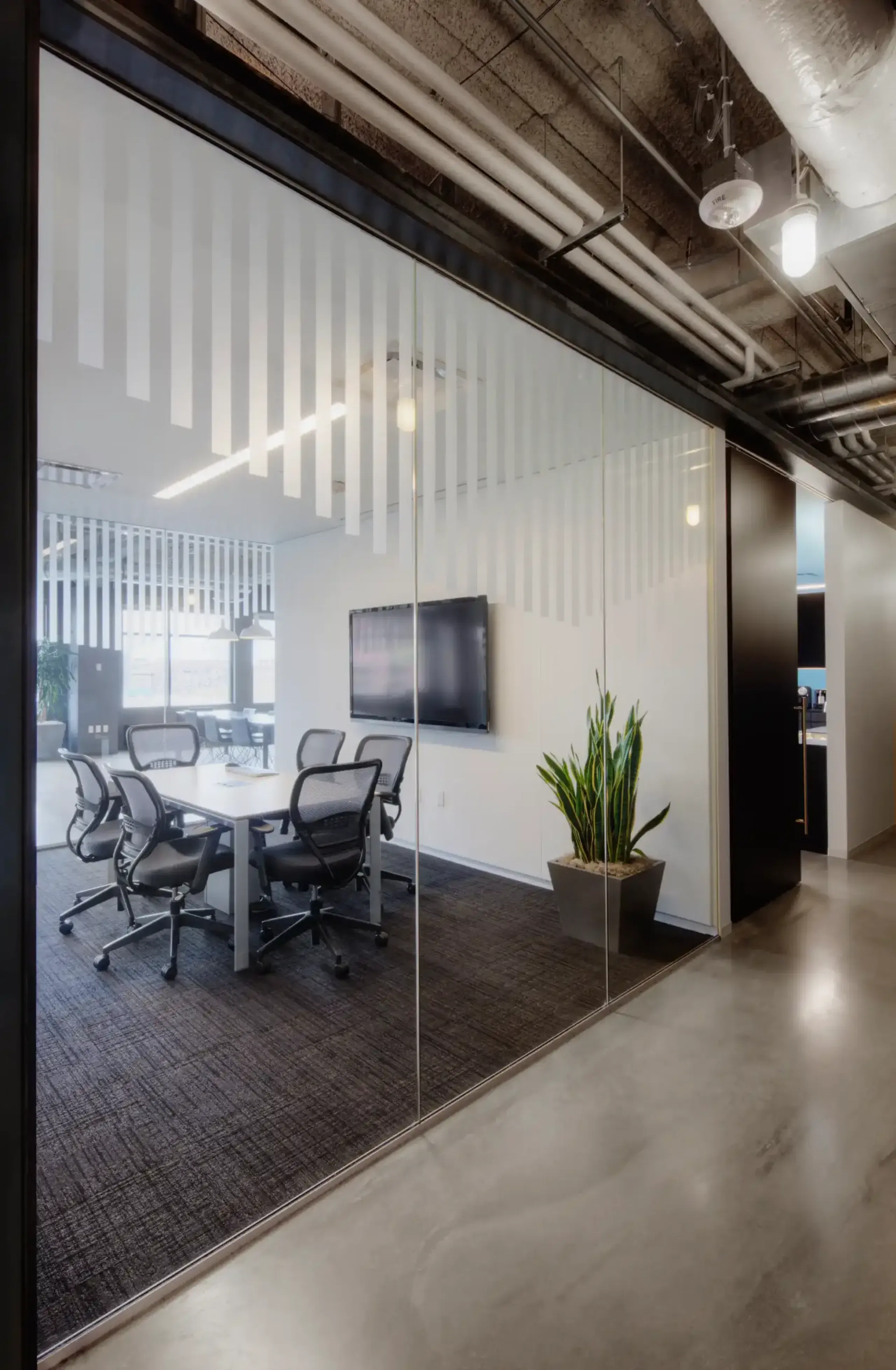 Modern conference room with Smart Frosted Stripe Film providing privacy while managing natural light in Los Angeles.