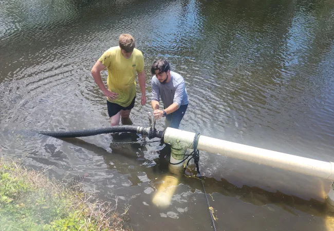 Technicians working on a large water management system