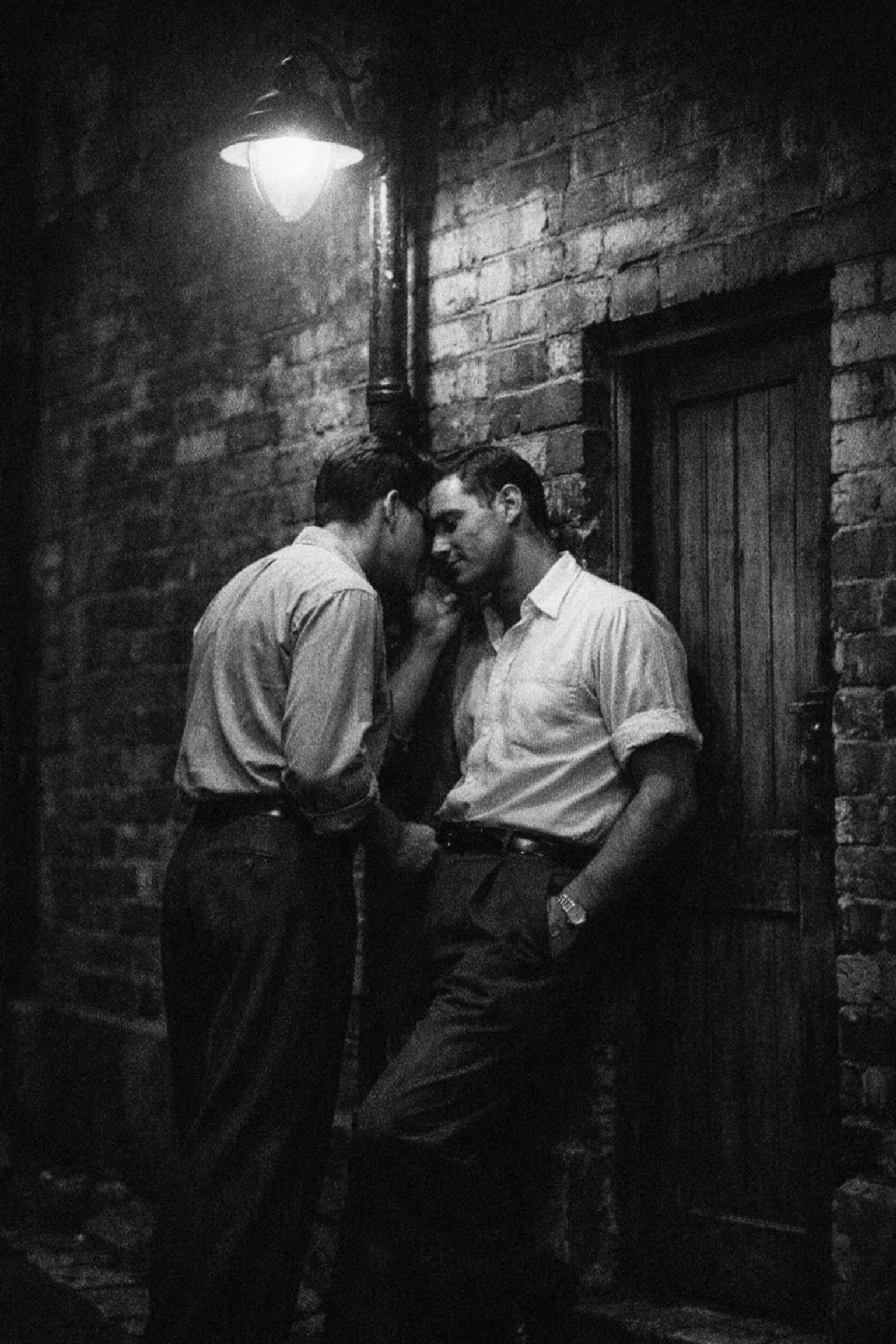 Vintage photo of two men in a Darlinghurst alley, reflecting the secret gay history of 1960s Oxford Street.