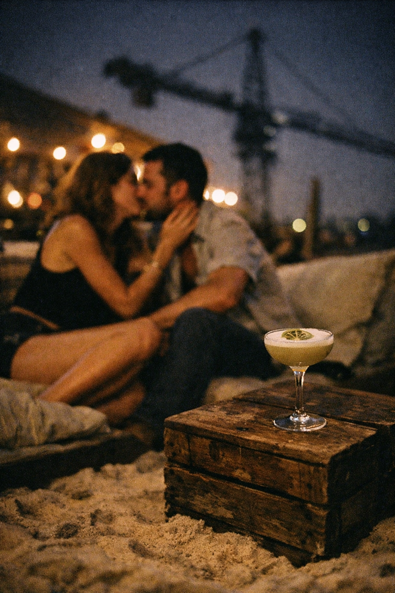 Intimate cocktails on the sand at an industrial Berlin beach bar with an urban view.