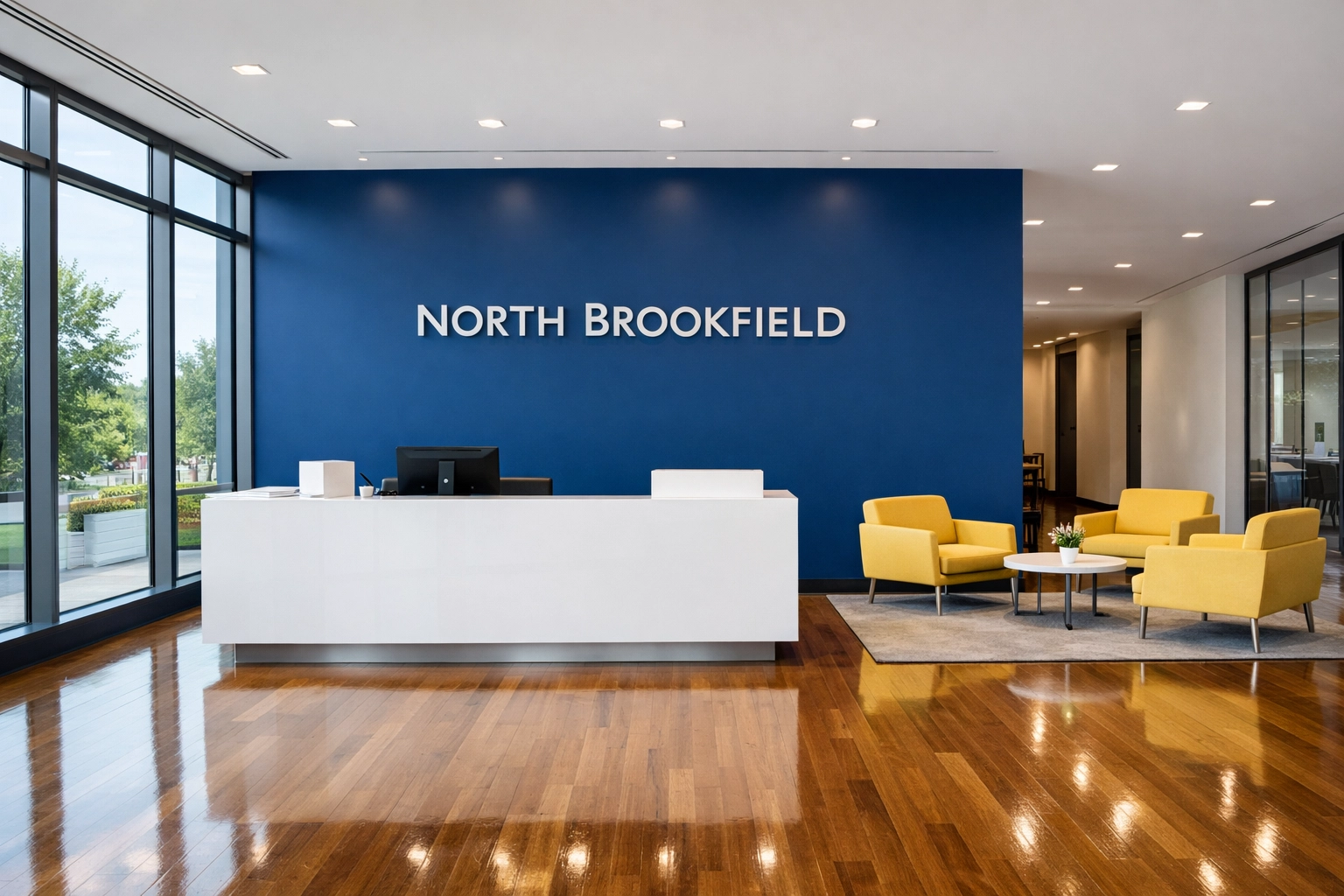 A professionally cleaned modern office lobby in North Brookfield, MA with shiny hardwood floors.