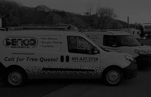 Denco Security service vehicles with mountains in the background