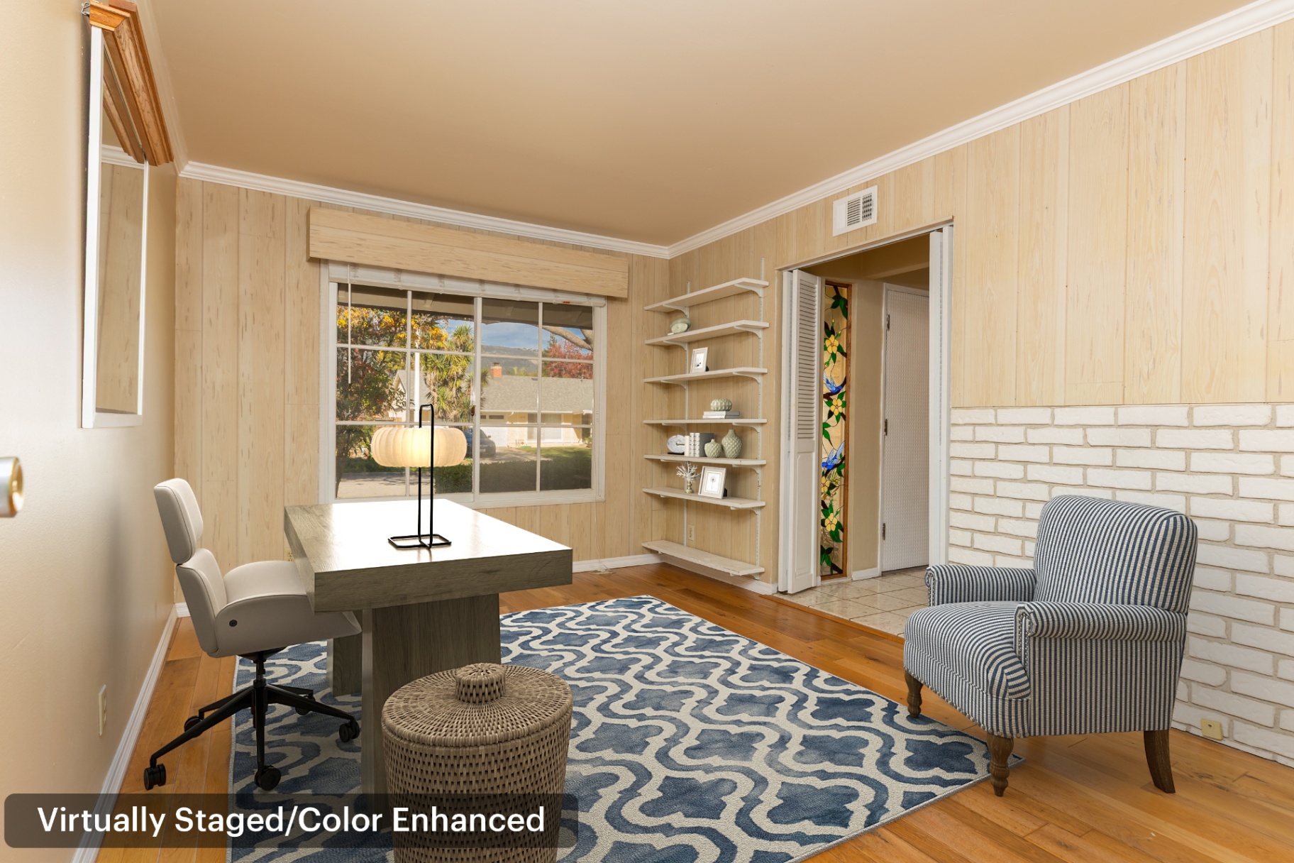 Home office (virtually staged) showing a comfortable work-from-home flex space