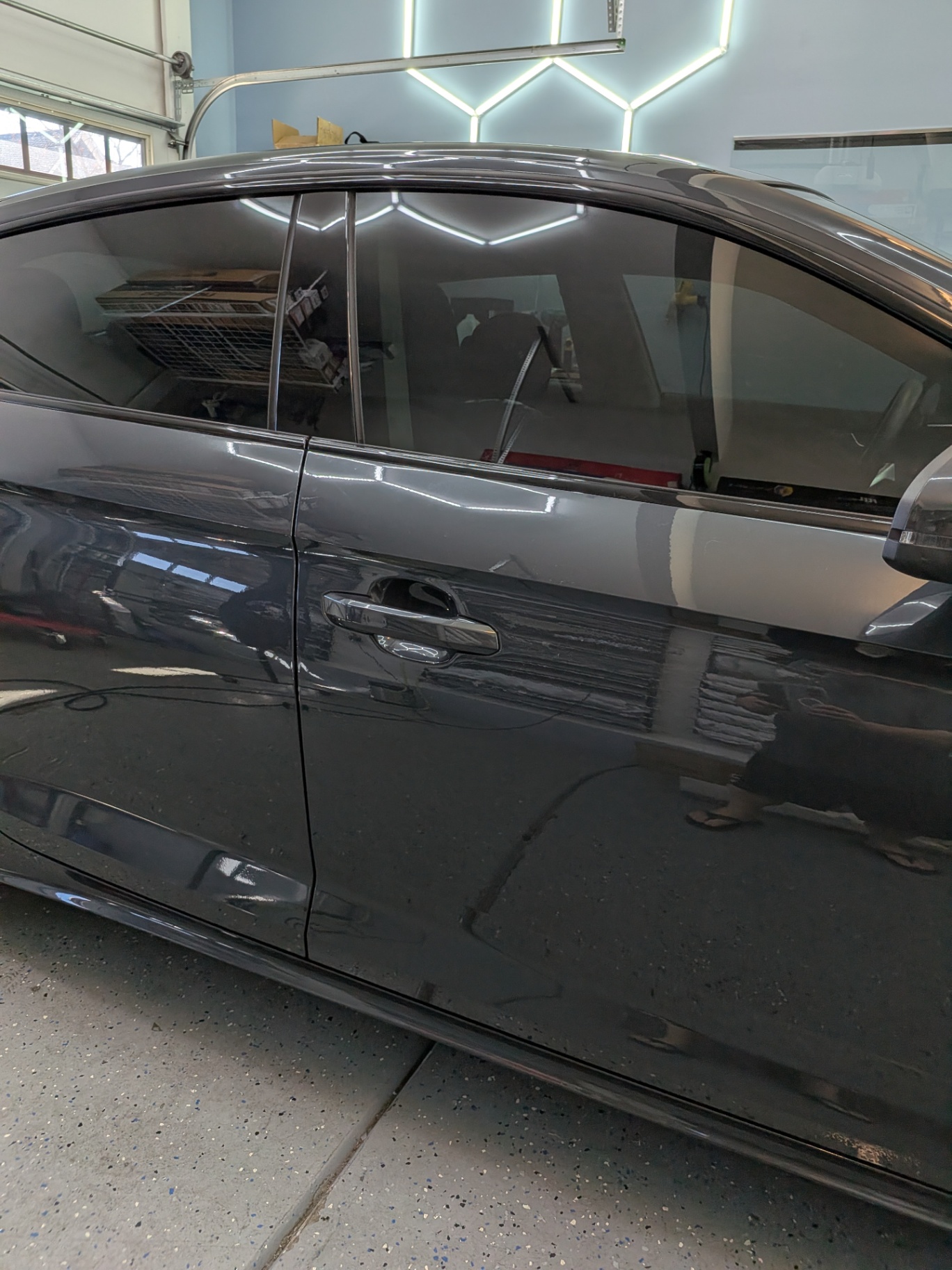 Dark gray sedan with freshly tinted windows