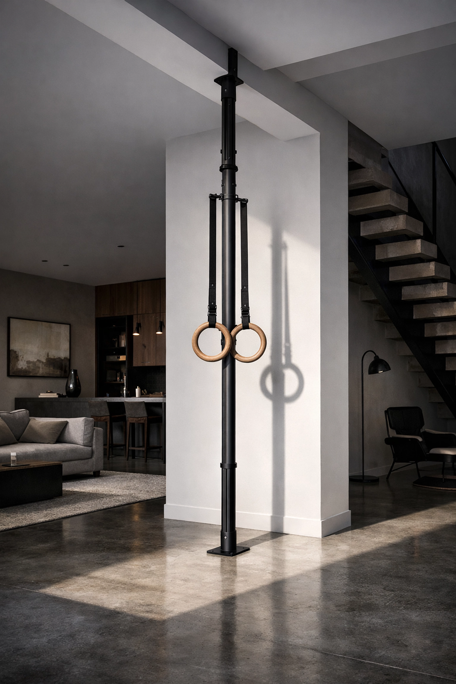 Resistance Rail floor to ceiling gym system with gymnastic rings in a minimalist home gym loft.