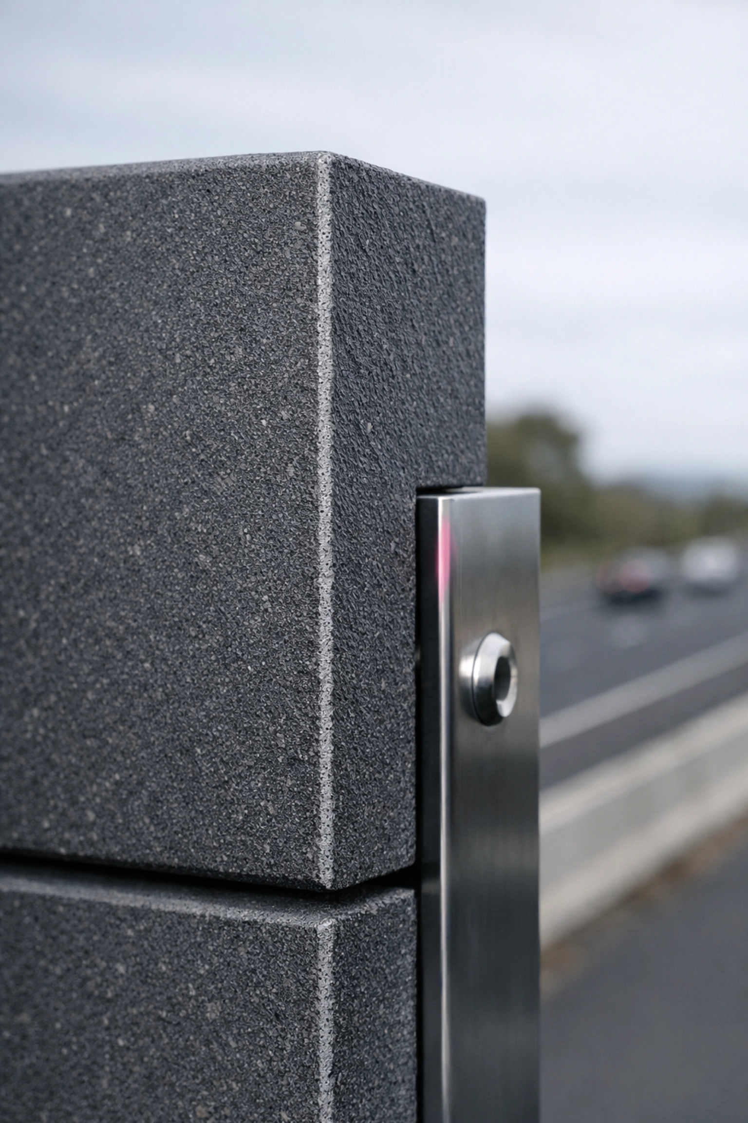 Close-up of a thick, durable recycled plastic noise wall panel edge installed on an Australian highway.