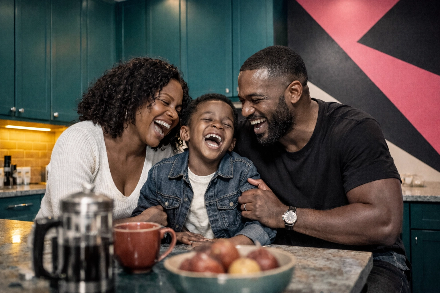A happy Black family cooking in a modern Gwinnett County kitchen with safe, high-end under-cabinet lighting.
