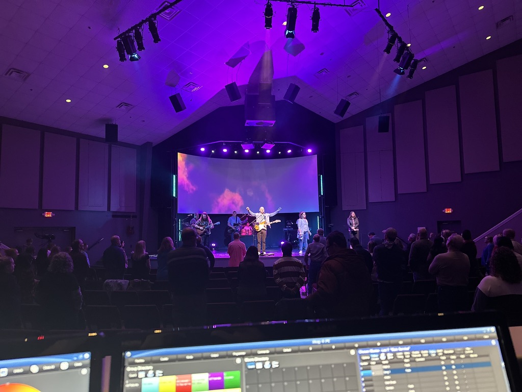 Congregation worship service with live band and professional lighting