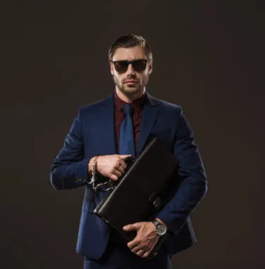 executive-protection-specialist-bodyguard-suit-briefcase.webp