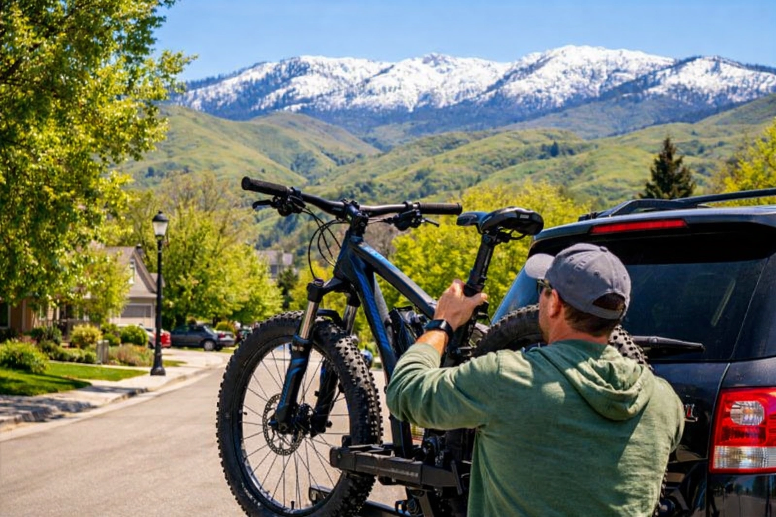 Loading a mountain bike in a sun-drenched Boise neighborhood with views of the snow-capped foothills.