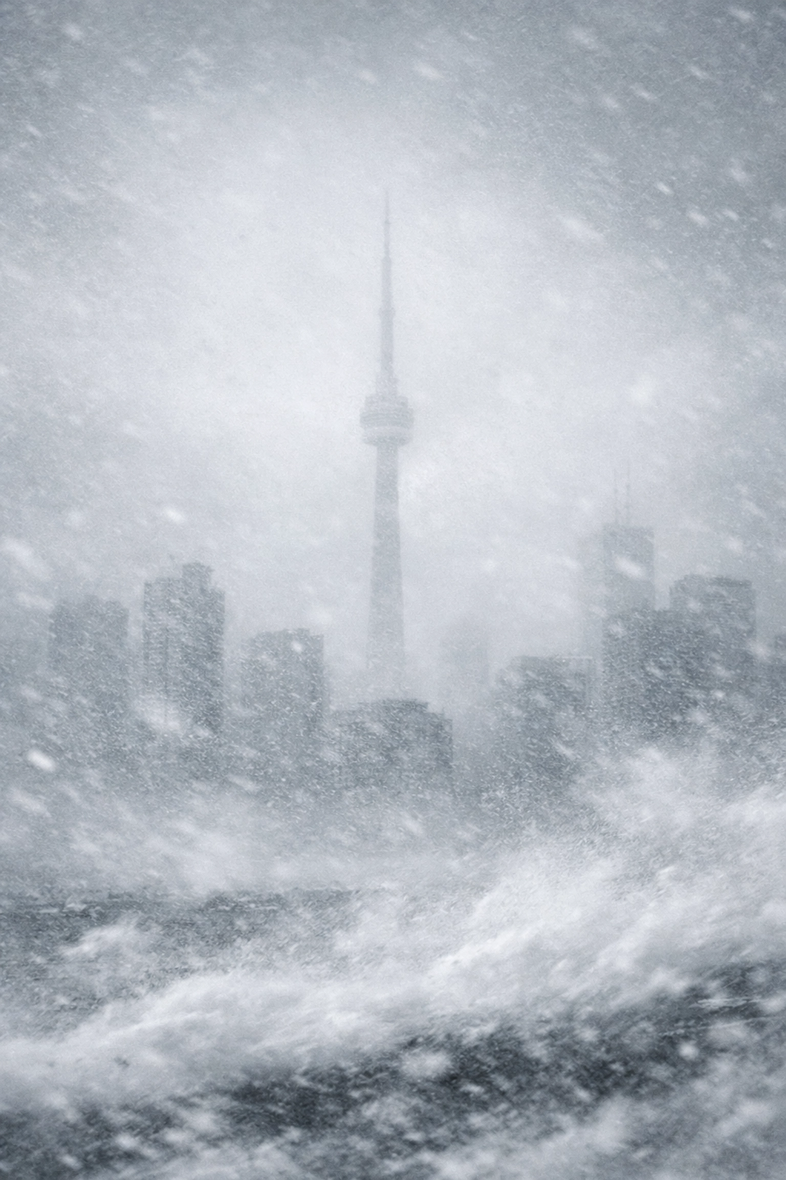 Toronto skyline obscured by heavy lake effect snow and extreme winter weather conditions