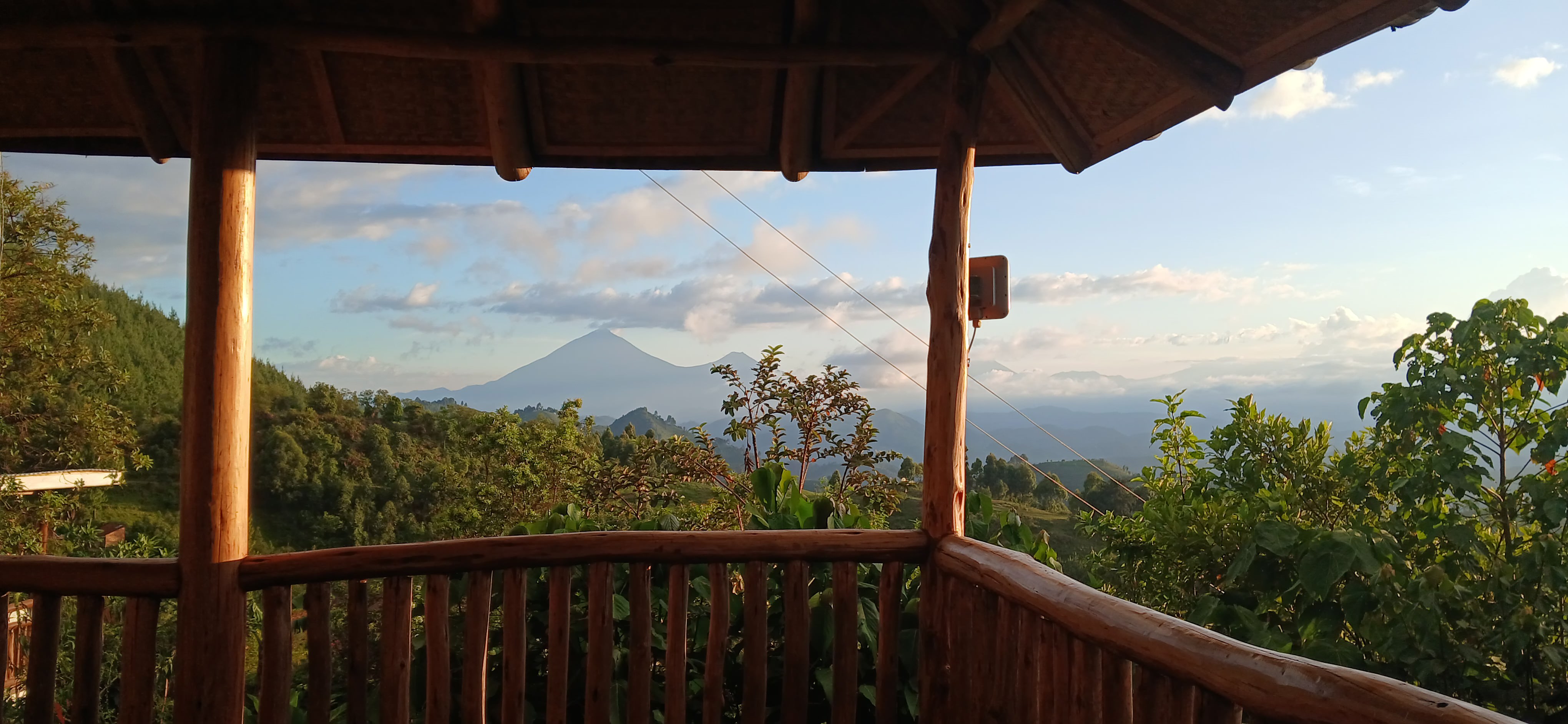 Breathtaking Virunga Volcanoes view from Orugano Bwindi Lodge balcony in the Nkuringo sector, Bwindi forest.