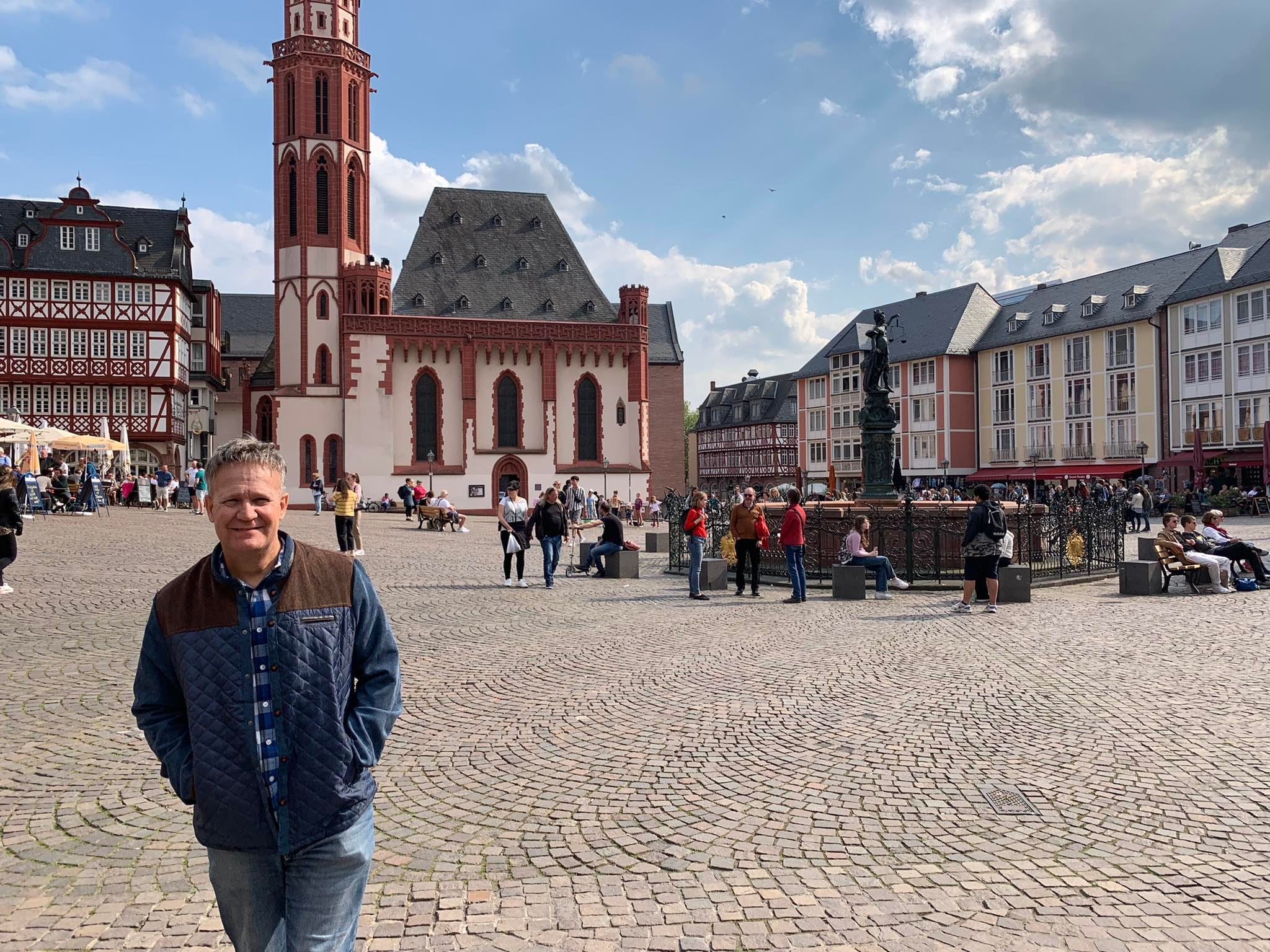 Dwayne Moore standing in a European Town Center, representing expansion and reaching new spiritual frontiers