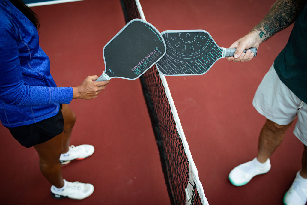 Player holding paddle on court