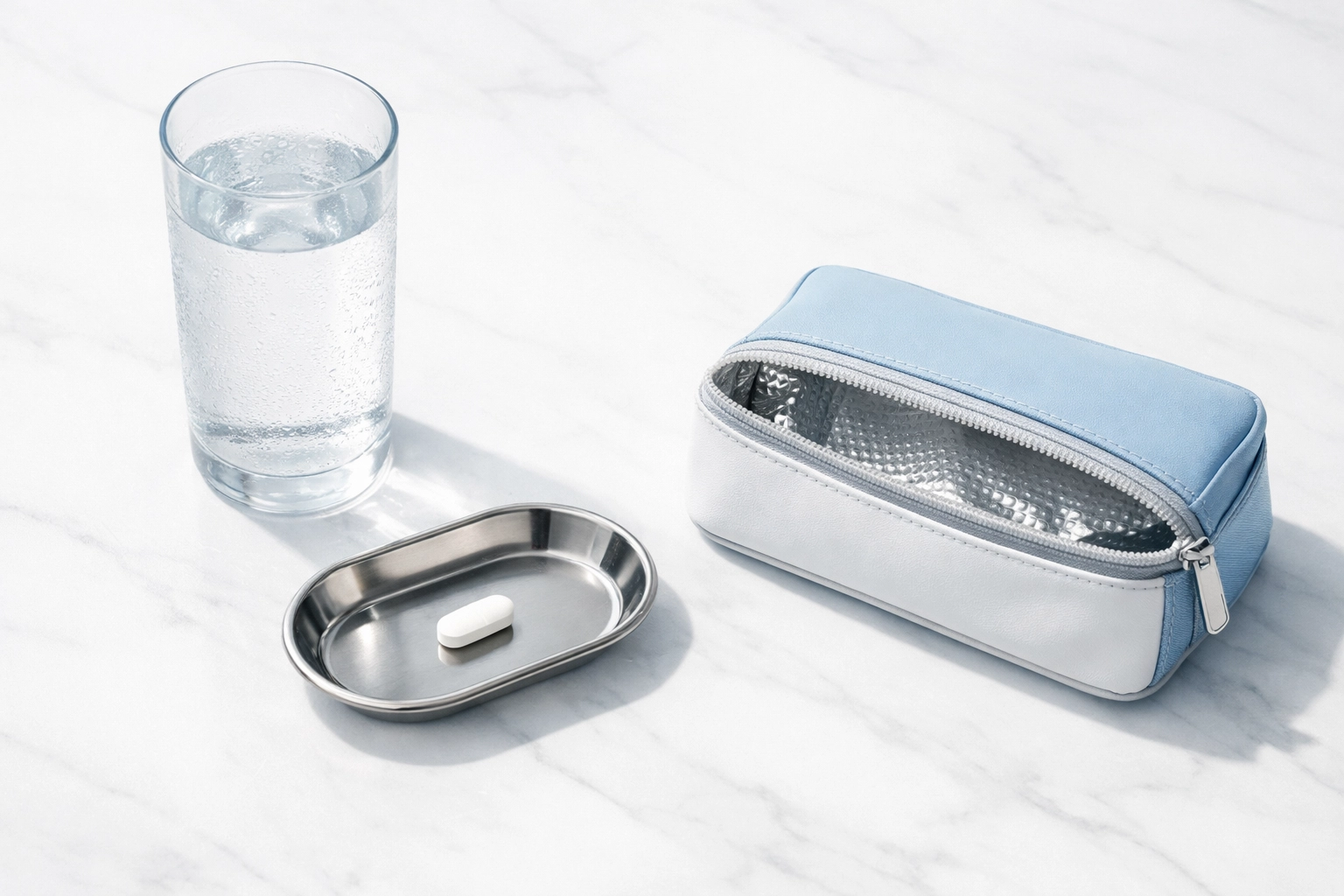 A medical tray featuring oral weight loss medication and a glass of water on a clean surface.