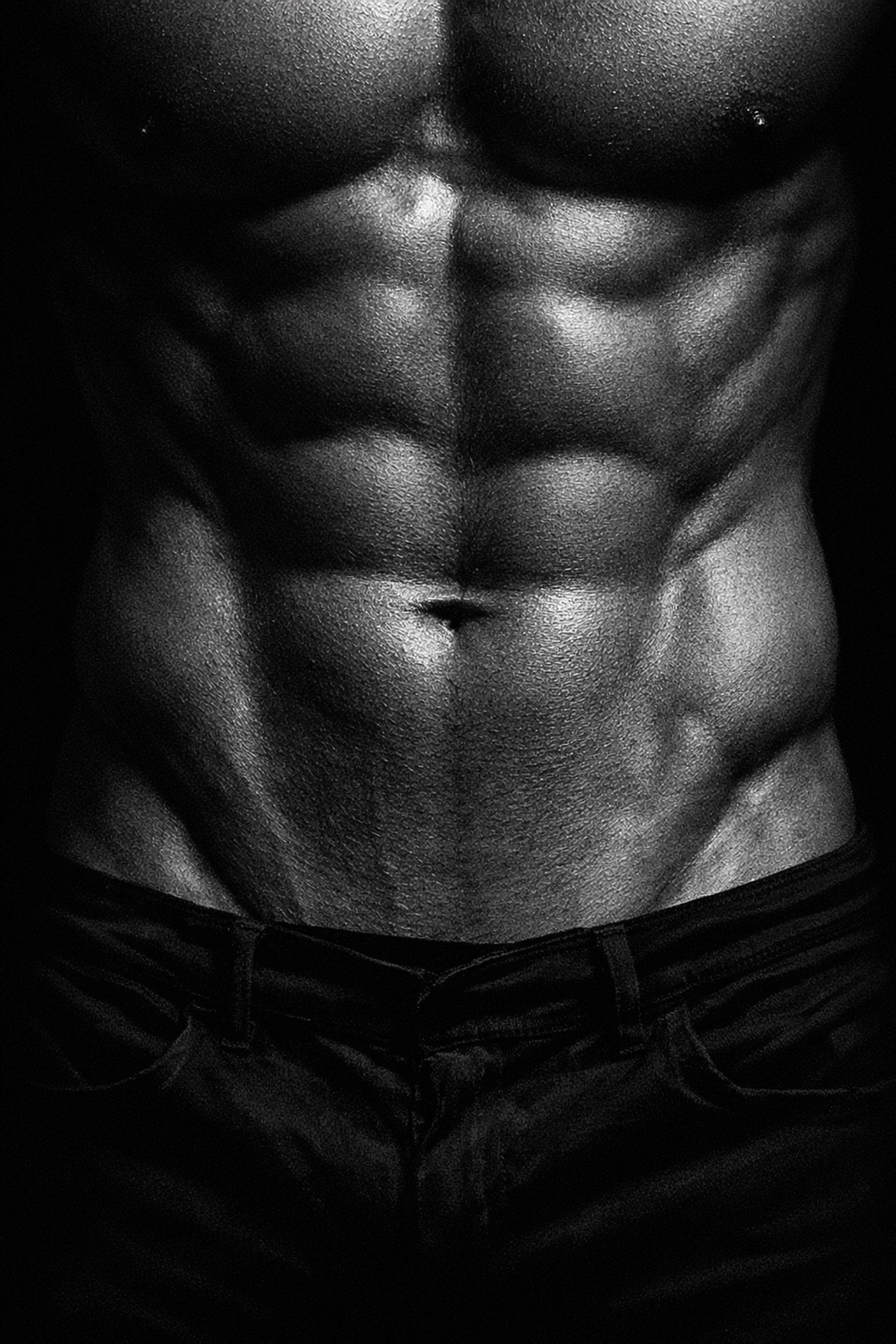 Fine art black and white photo of a man's sculpted Adonis Belt, a popular trope in gay fiction.