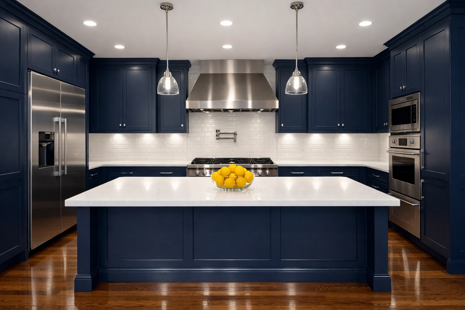 Spotless modern kitchen with navy cabinets and white counters after professional house cleaning in Hudson.