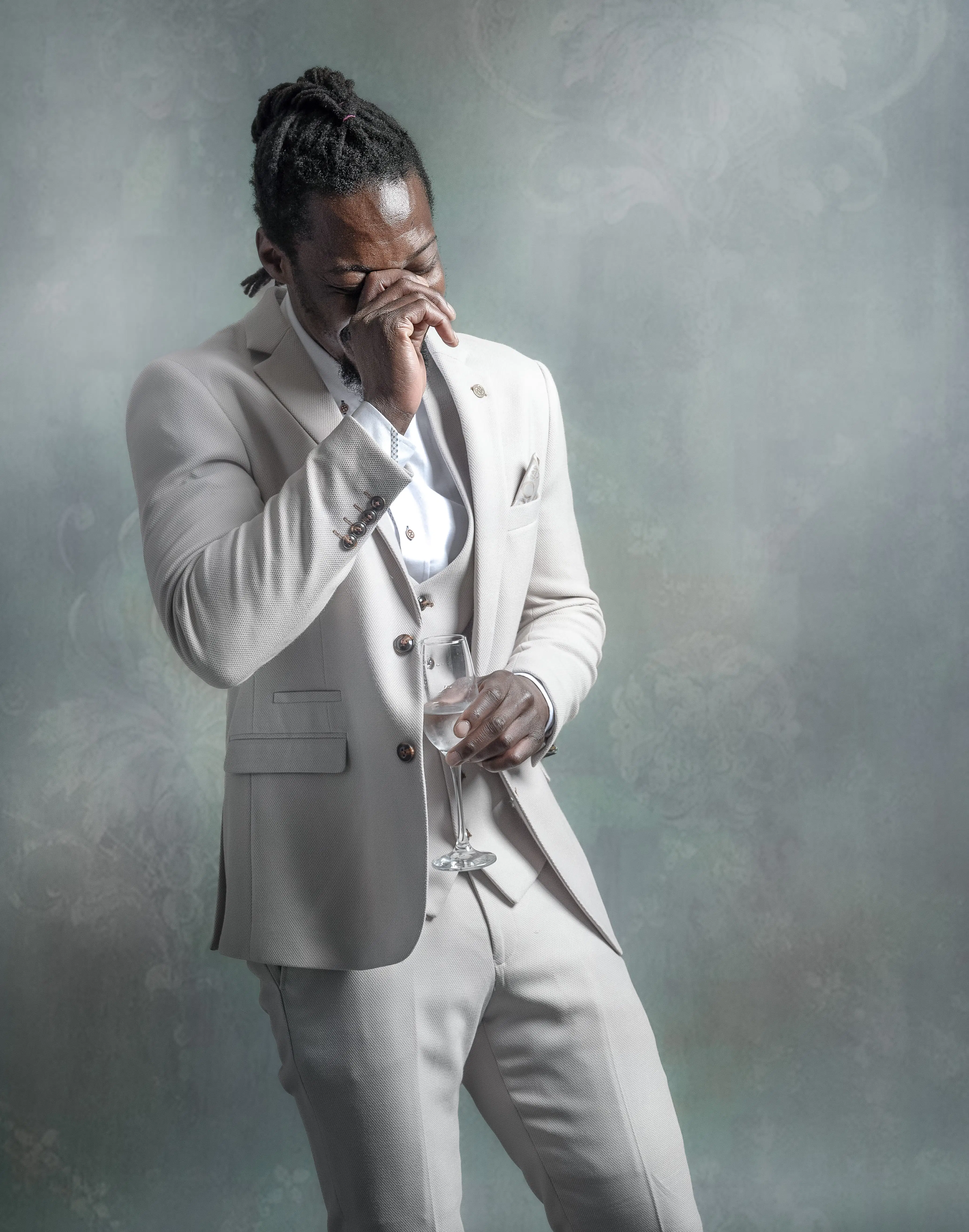 A groom models the Marc Darcy “Revere” suit in soft ivory, featuring a tailored jacket, matching waistcoat, and slim-fit trousers.