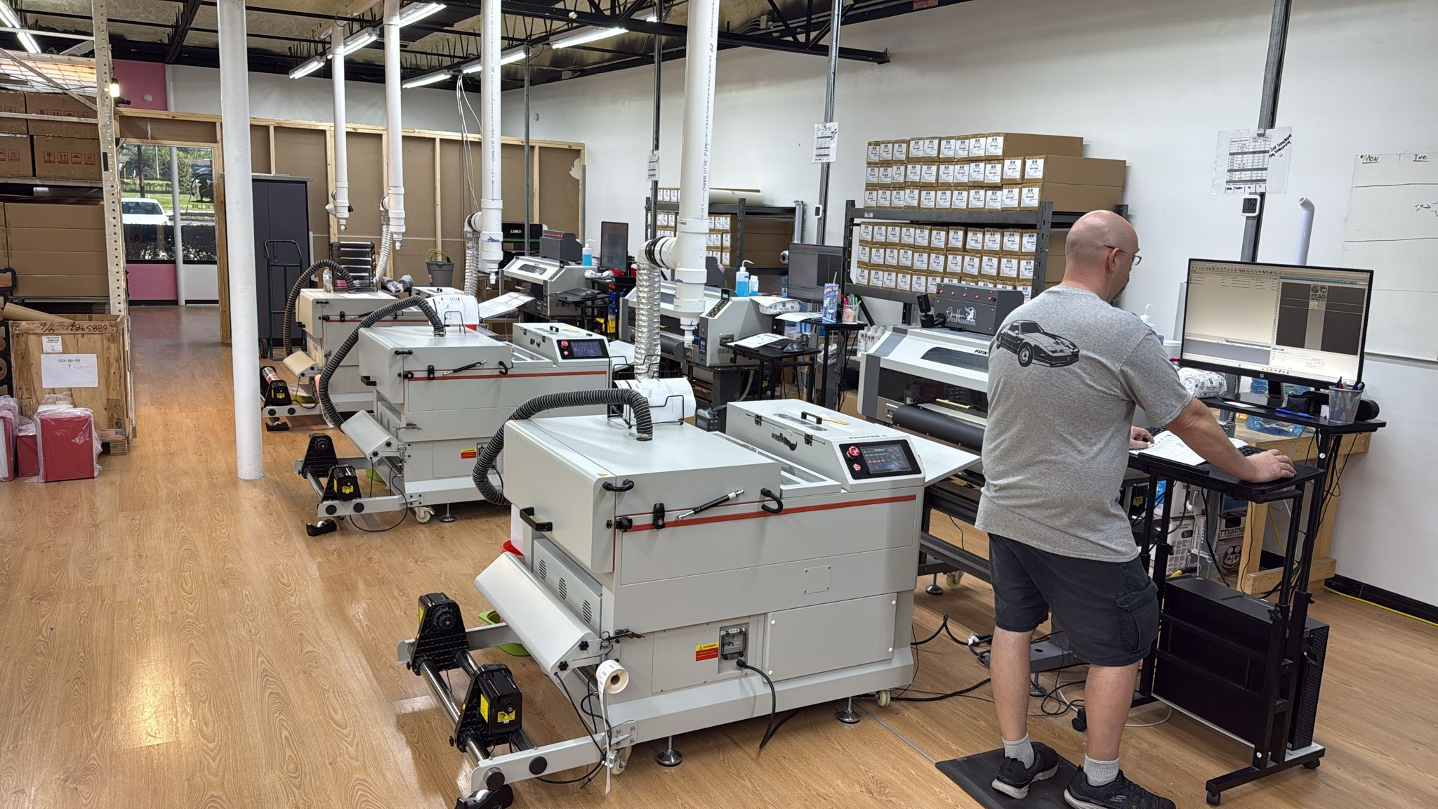 Production area with industrial DTF printing machines at Griffin Expressions