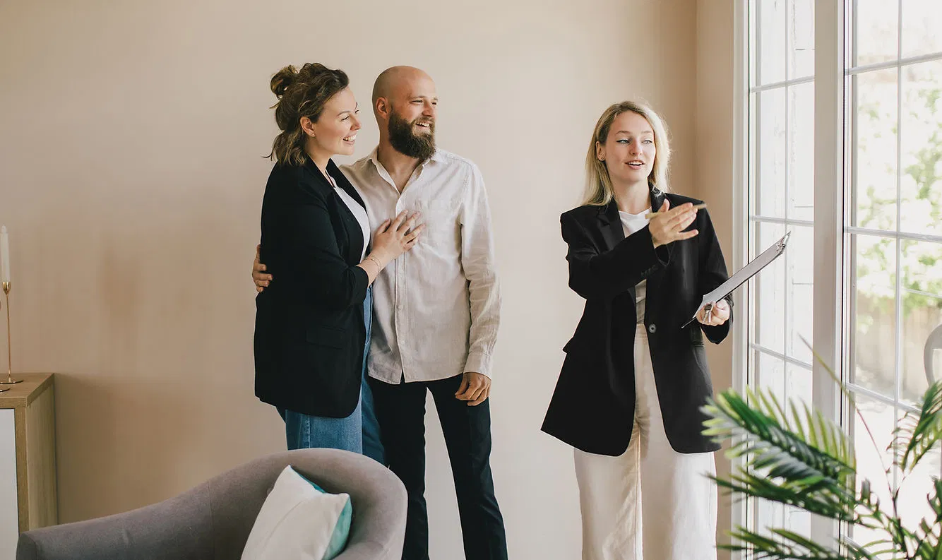 A Riveter Group agent provides a welcoming home tour to clients, highlighting features and answering questions.