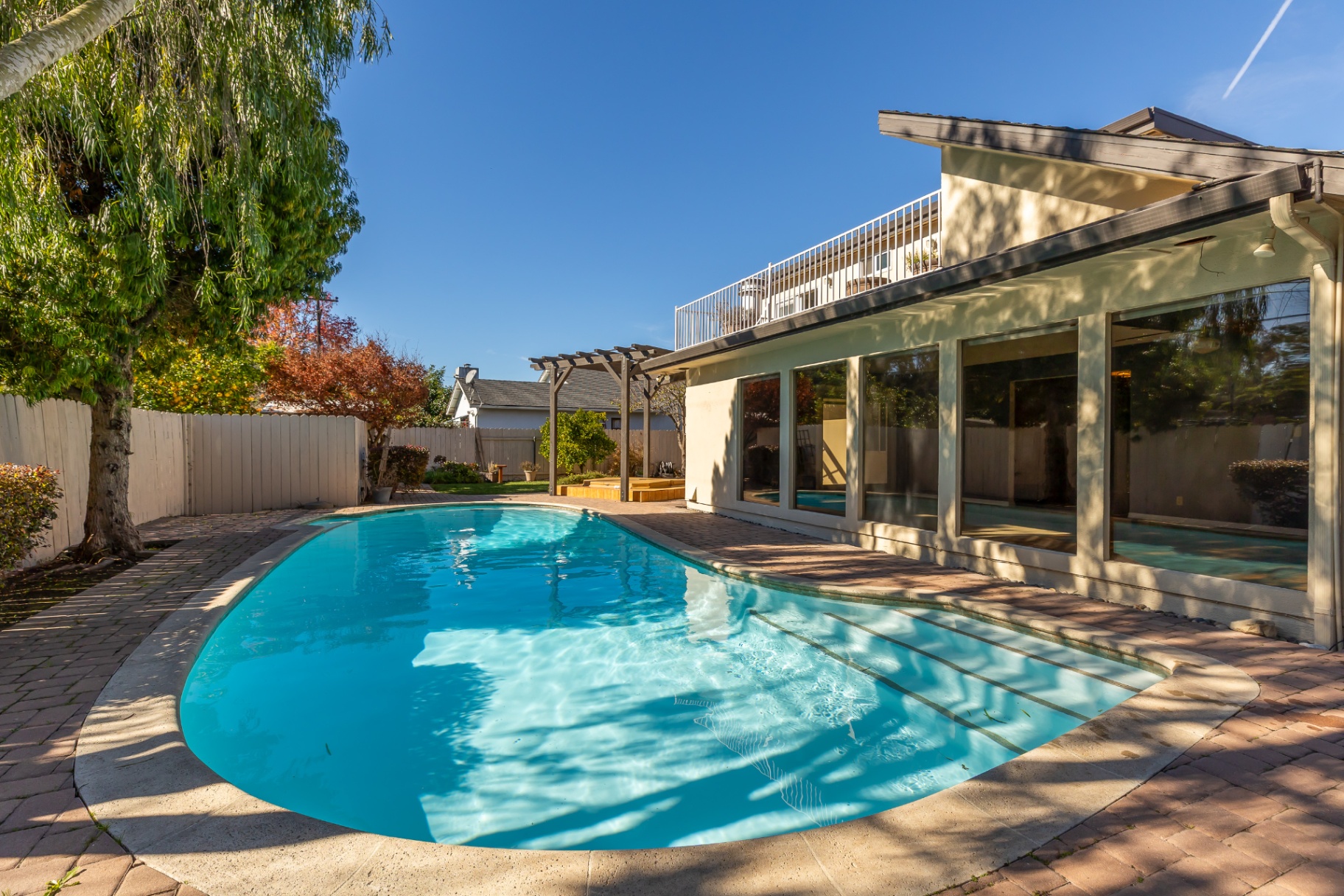 Backyard featuring a private solar-heated pool