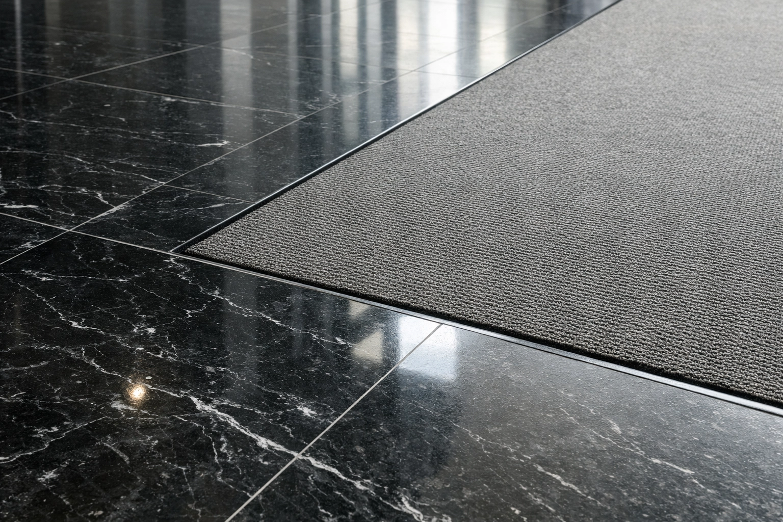 Clean commercial lobby floor with polished marble and pristine carpet in a Midwest facility.