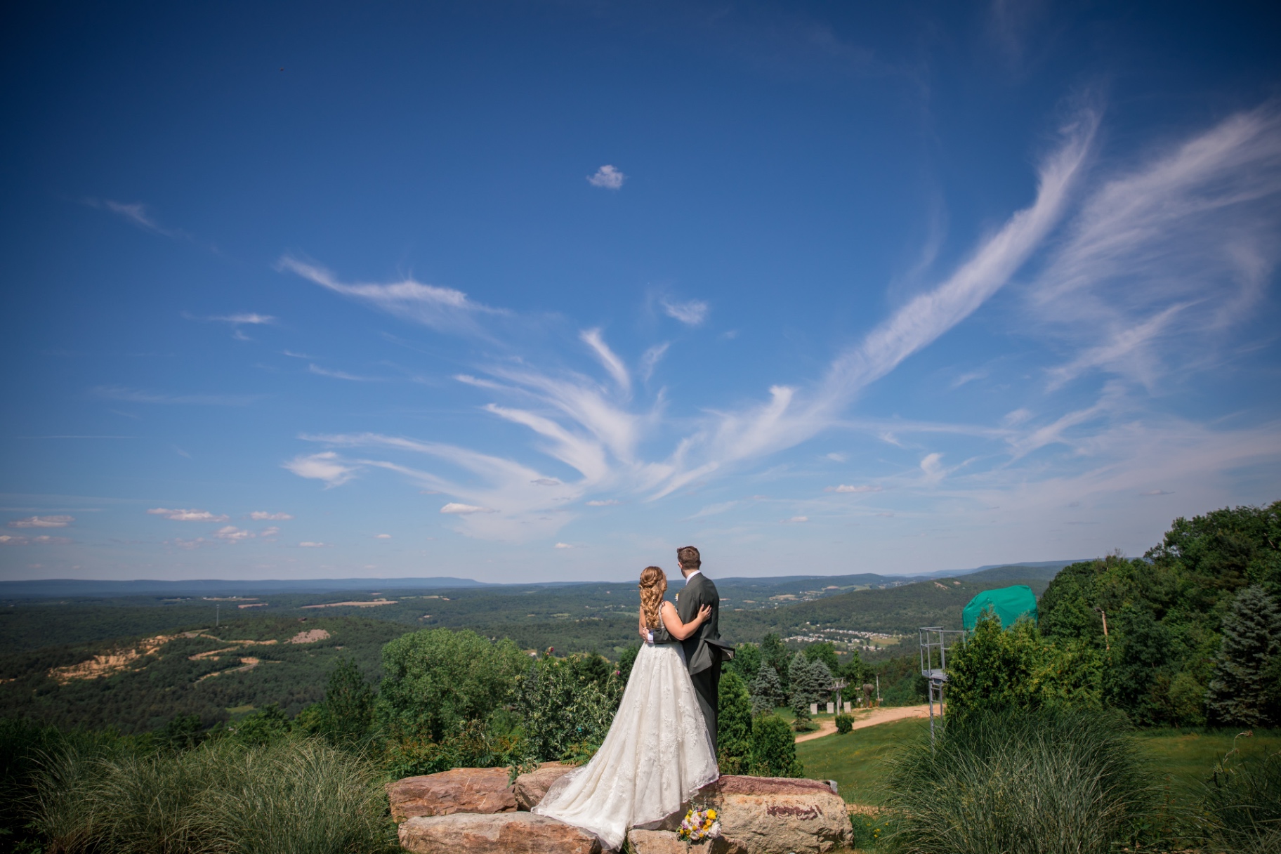 Bride and Groom on Rock Outcrop overlooking the valley