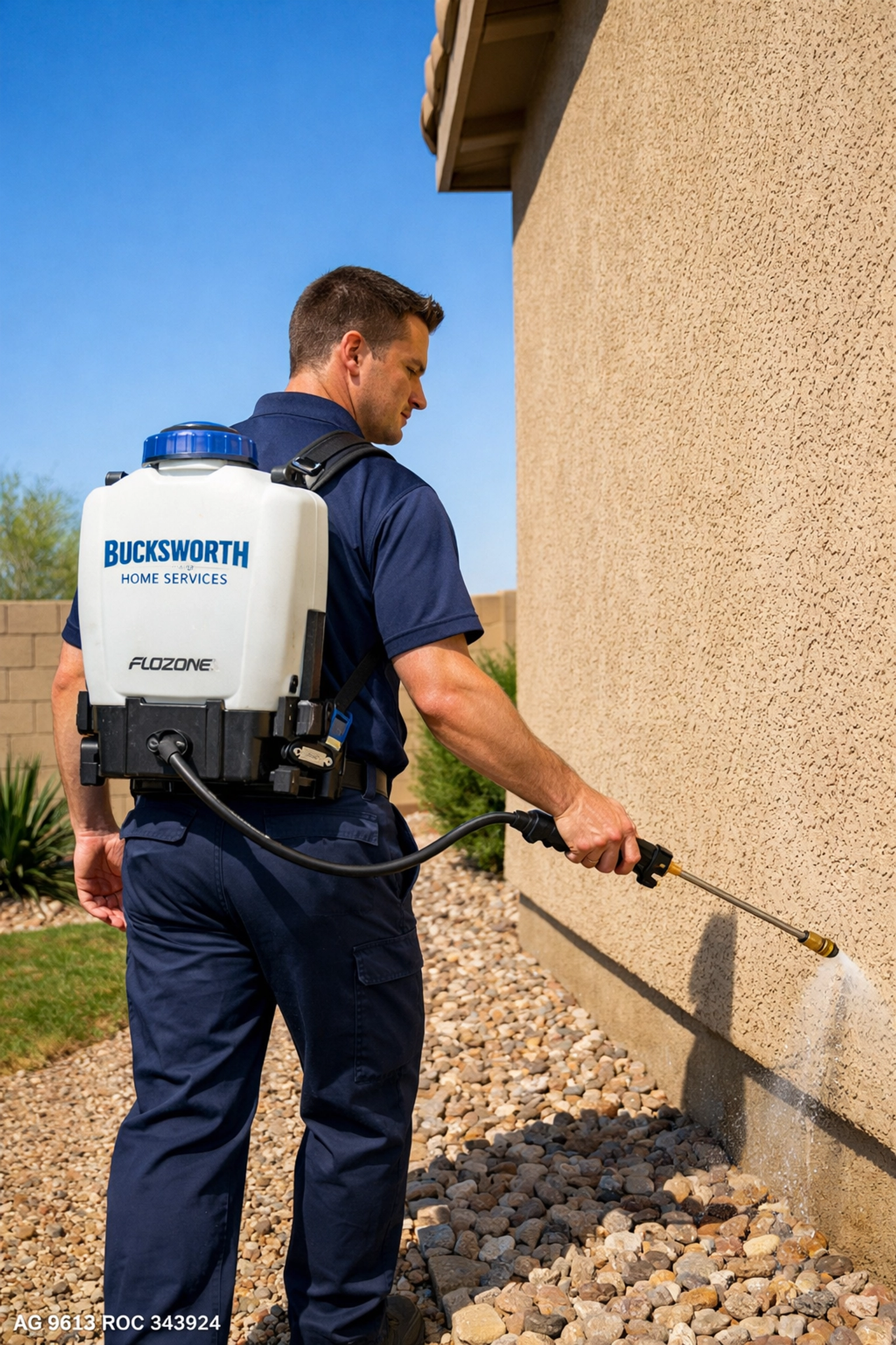 Professional Bucksworth technician applying a liquid perimeter pest barrier to a home in Mesa, AZ.