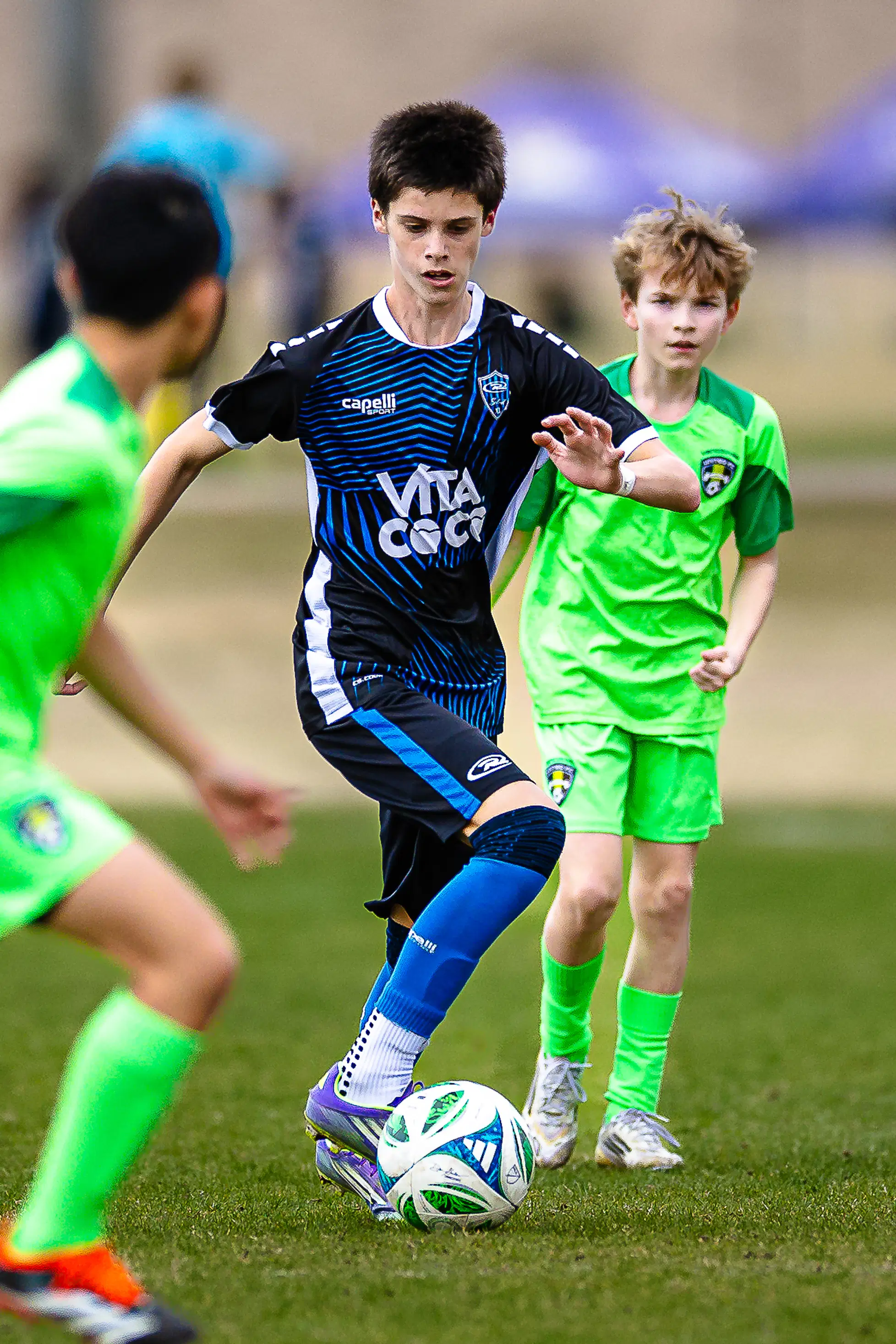 High-intensity midfield action captured with professional clarity, highlighting the fluid movement of youth soccer.