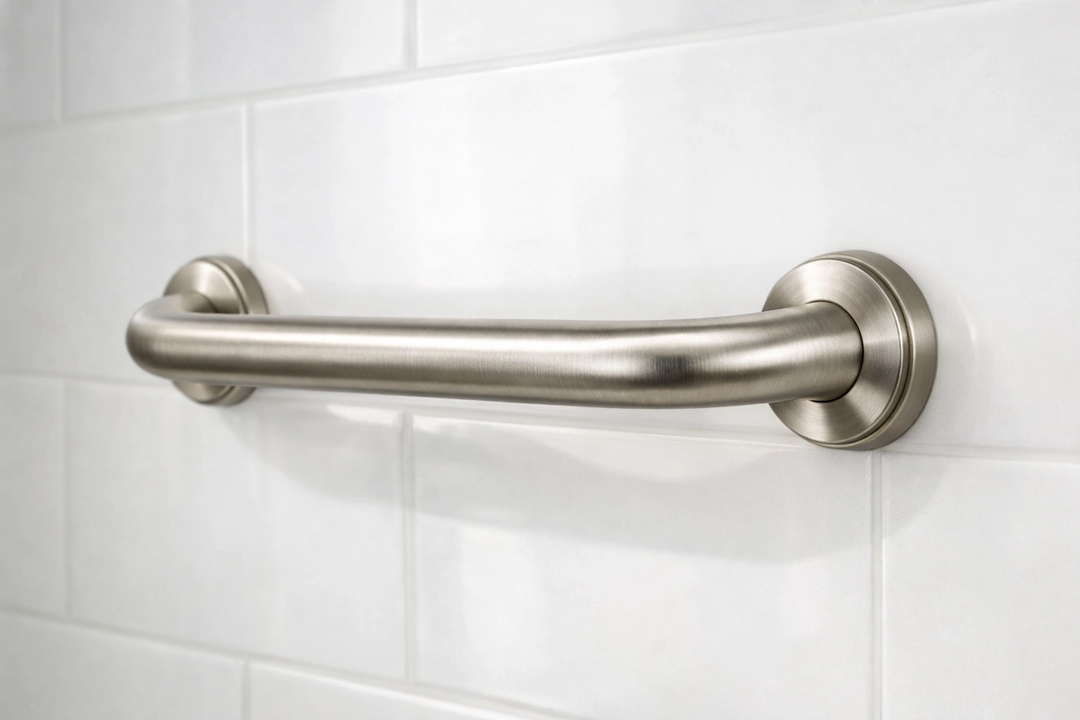 Sturdy brushed-nickel grab bar installed on a bathroom wall for stable support and fall prevention.