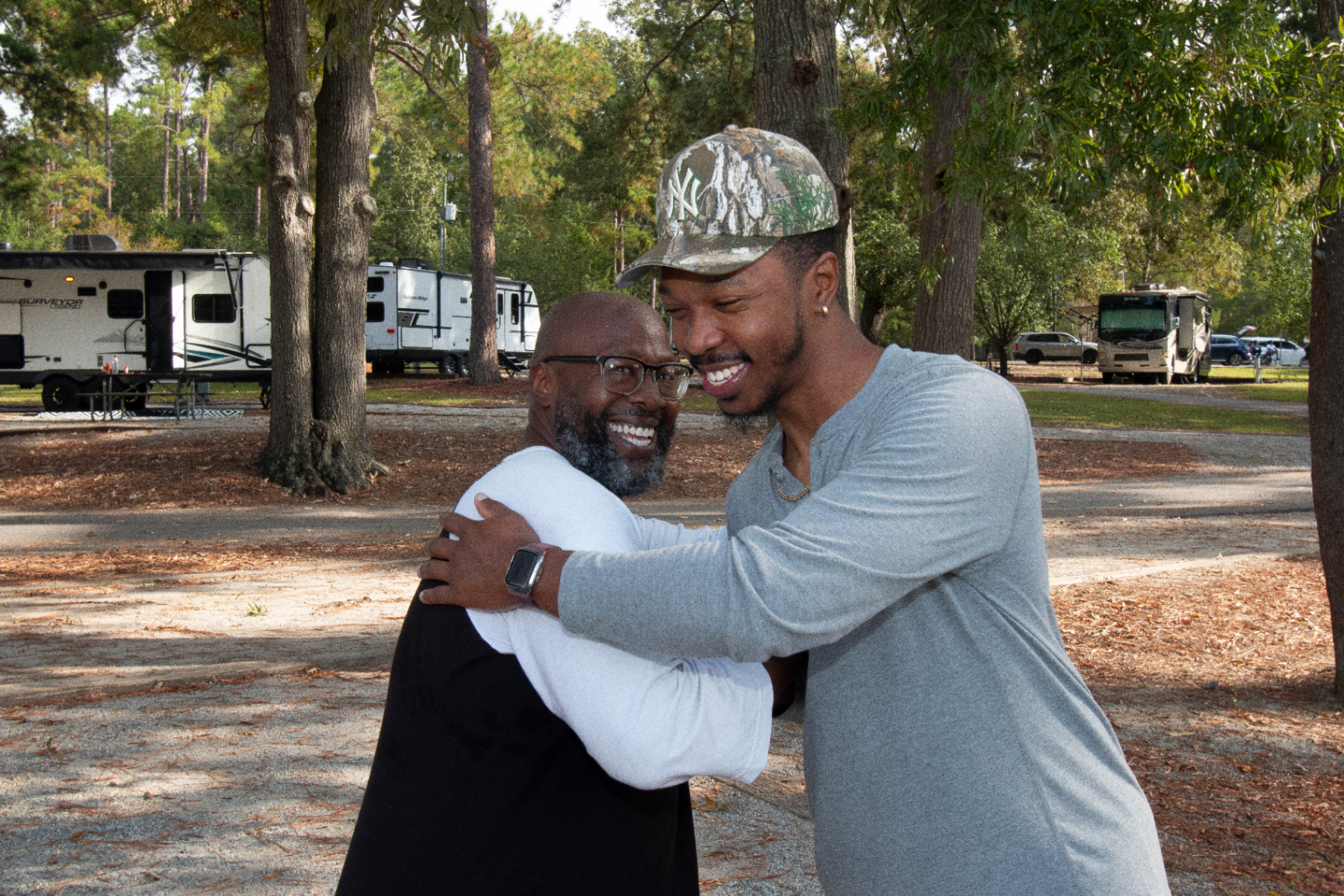 Two Black men greet each other at Melanated Campout