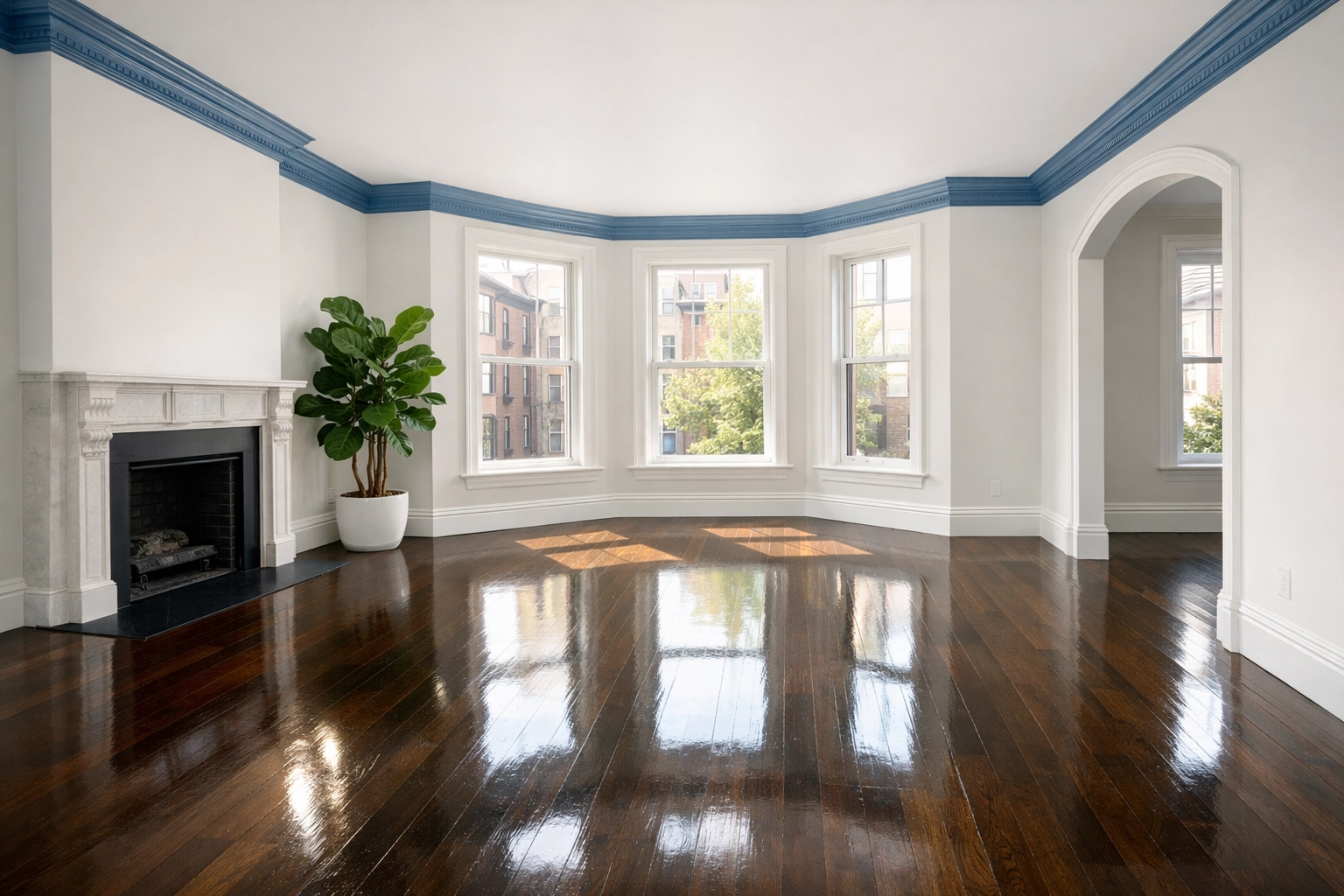 Sunlit empty living room with polished hardwood floors after a professional move-in cleaning in Massachusetts.