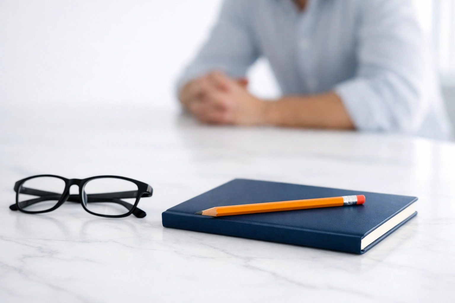 A notebook and glasses representing active listening and consultative selling techniques.
