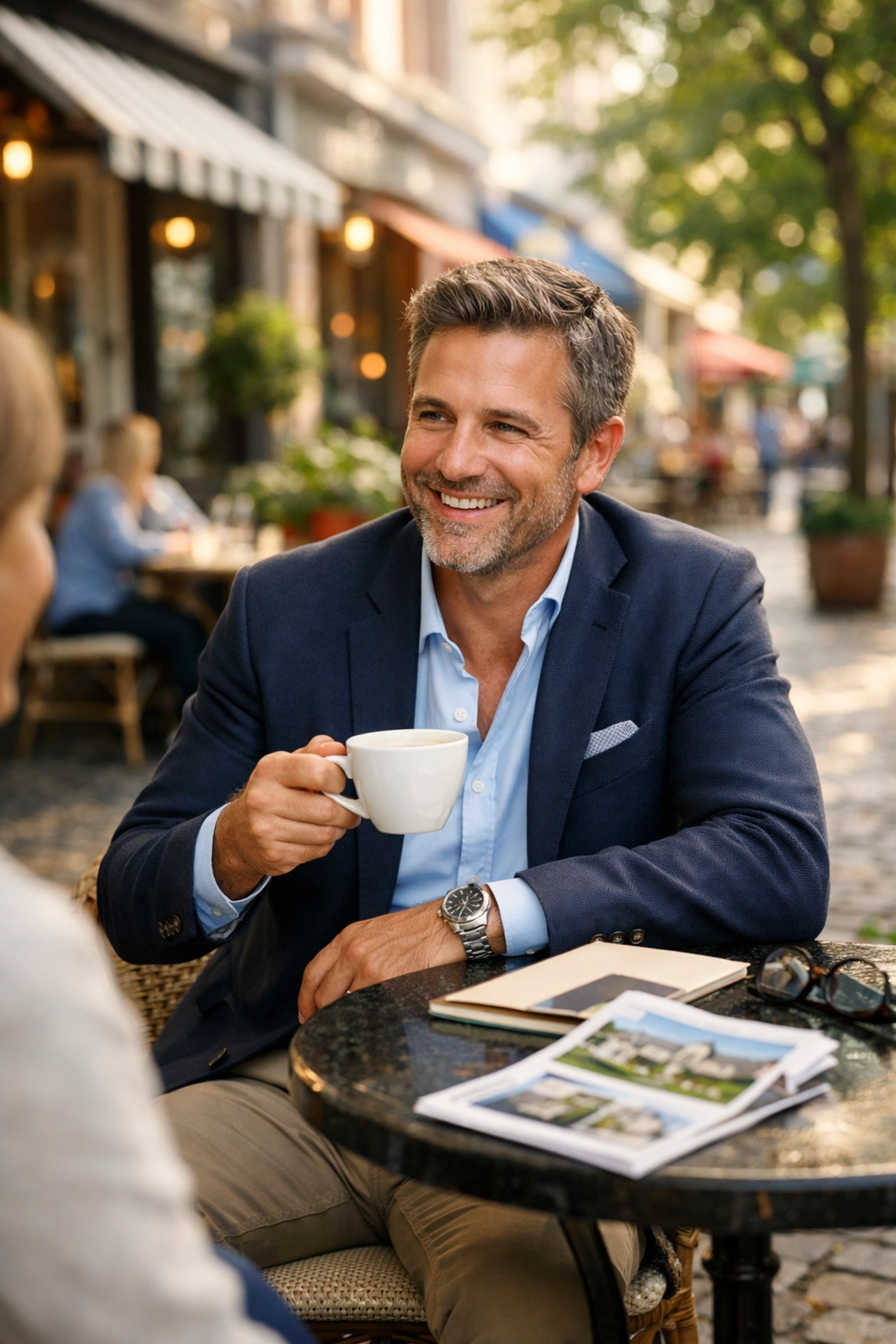 Luxury realtor at an outdoor café in an upscale neighborhood building local market authority.
