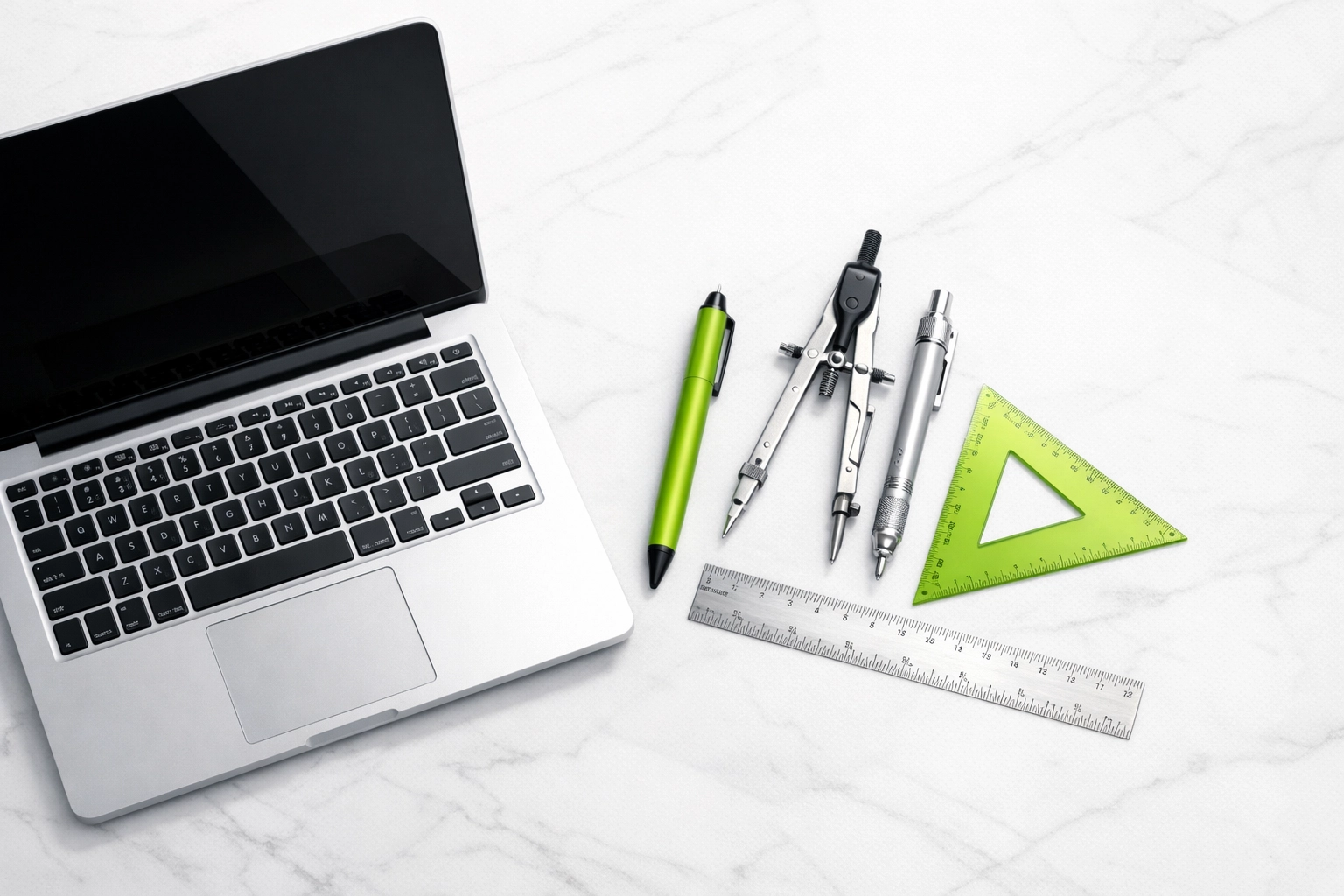 Modern laptop on white marble highlighting custom web development and fast site performance.