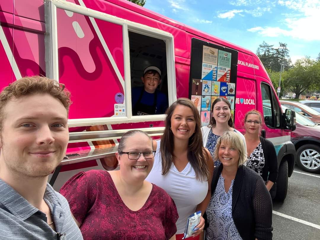 Employees gathering around The Ice Cream Truck at a corporate workplace event in Canada.