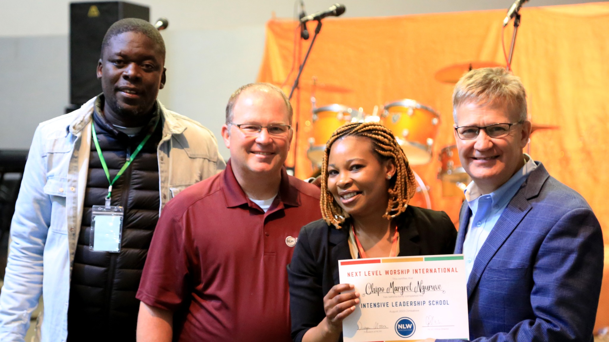 A group at NLW Leadership School, one holding a certificate