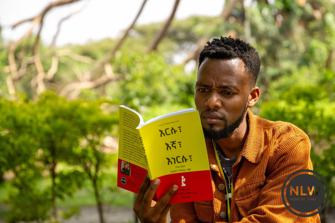 Ethiopian man reading NLW resource outdoors, demonstrating direct impact on local leaders