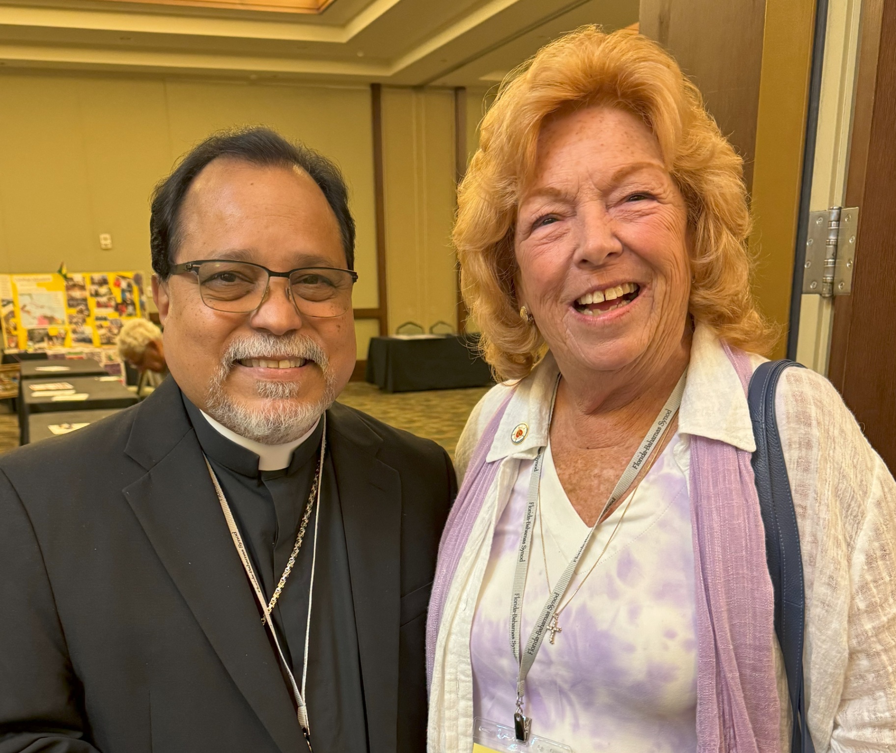A Lutheran pastor and a smiling woman at a ministry event