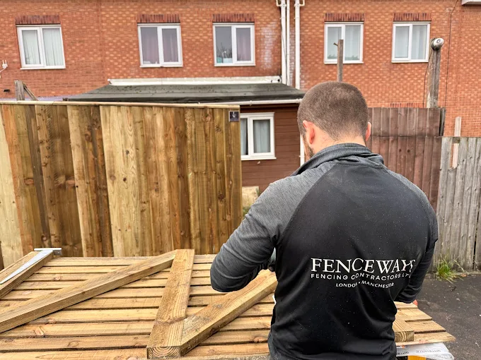 A Fenceways Group team member assembles premium timber fence panels, demonstrating quality craftsmanship and attention to detail.