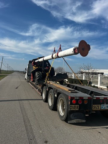 Oversized heavy machinery on flatbed trailer