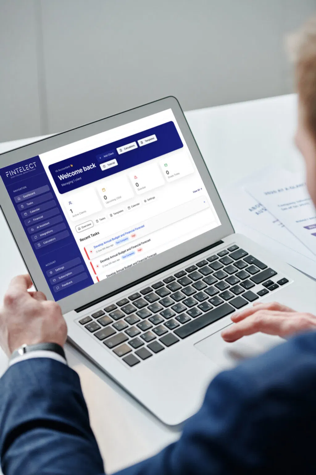 Fintelect user interface on a laptop showing seamless SaaS integration for compliance.