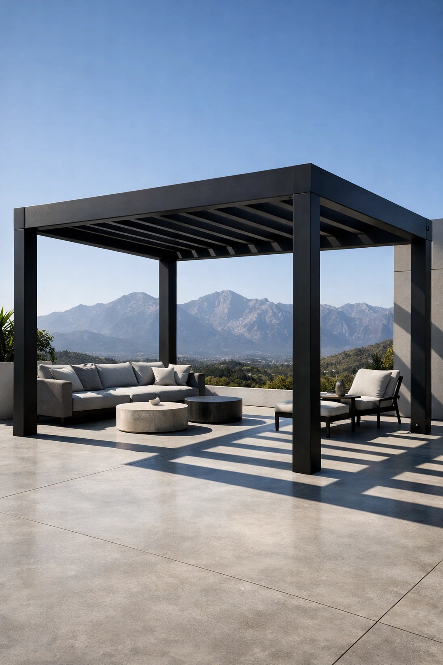 Minimalist matte black aluminum pergola on a modern concrete patio with mountain views.