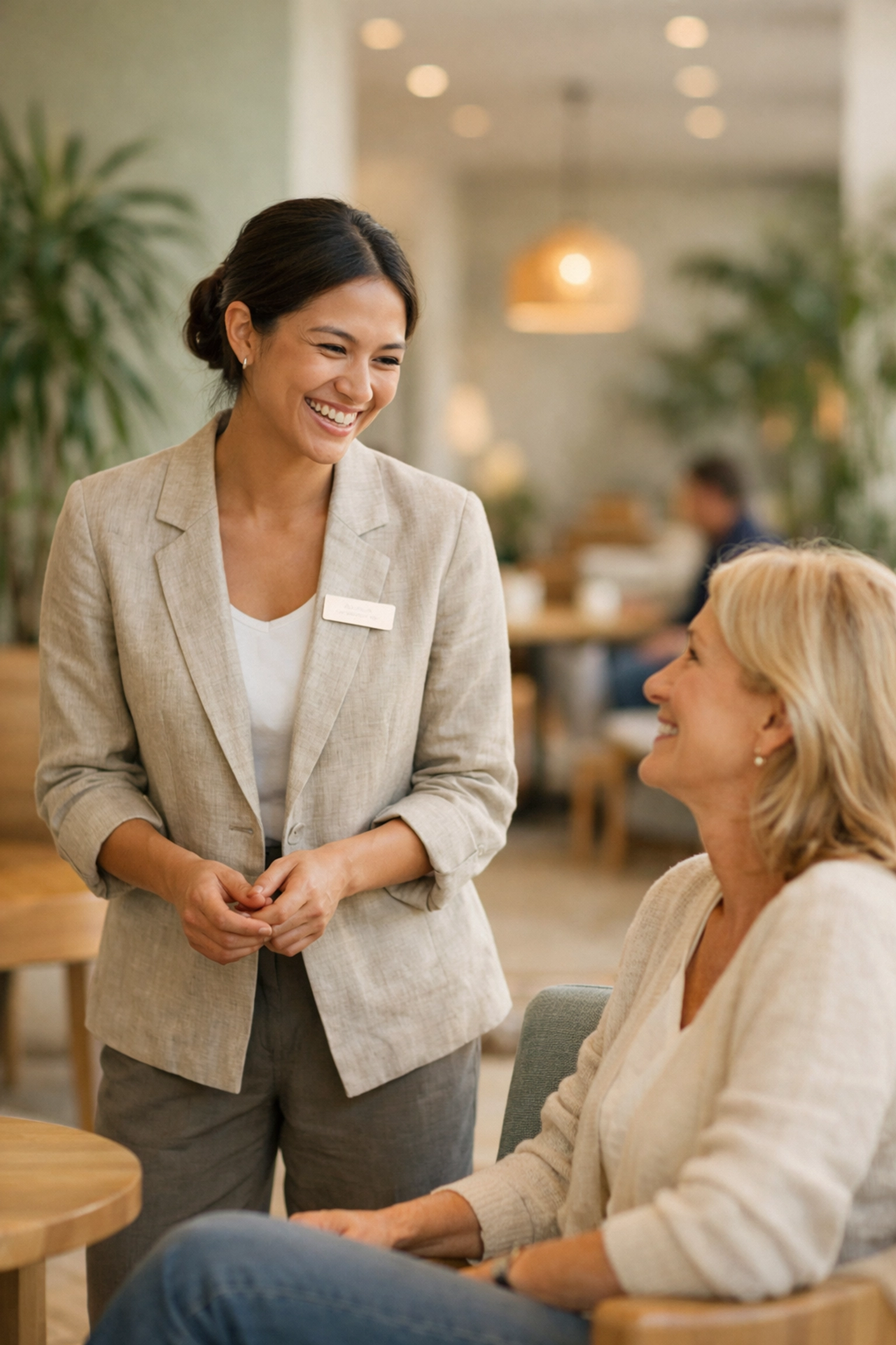 Friendly guest interaction in a modern hotel lobby, highlighting human-centric hospitality technology.